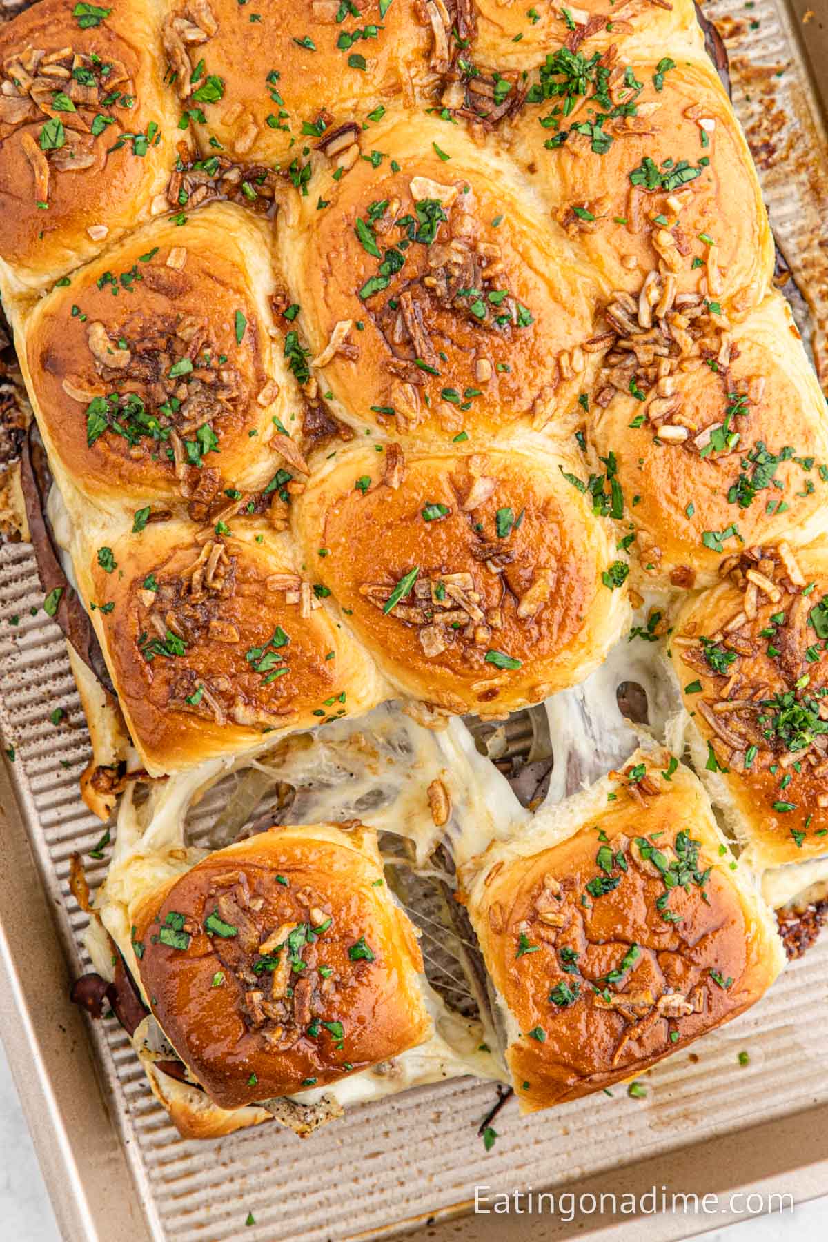 French dip sliders on a baking sheet