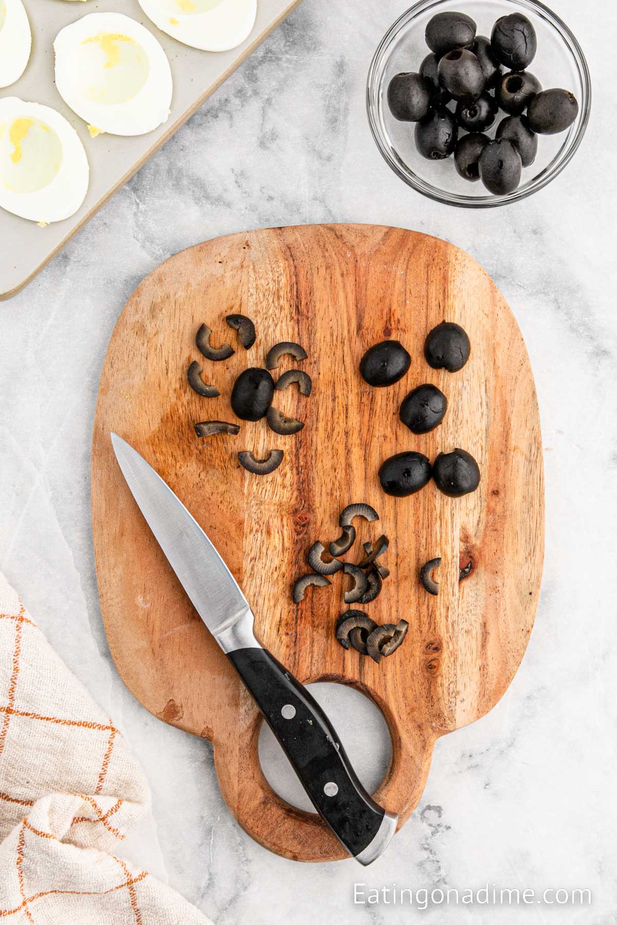 Slicing the back olives on a cutting board