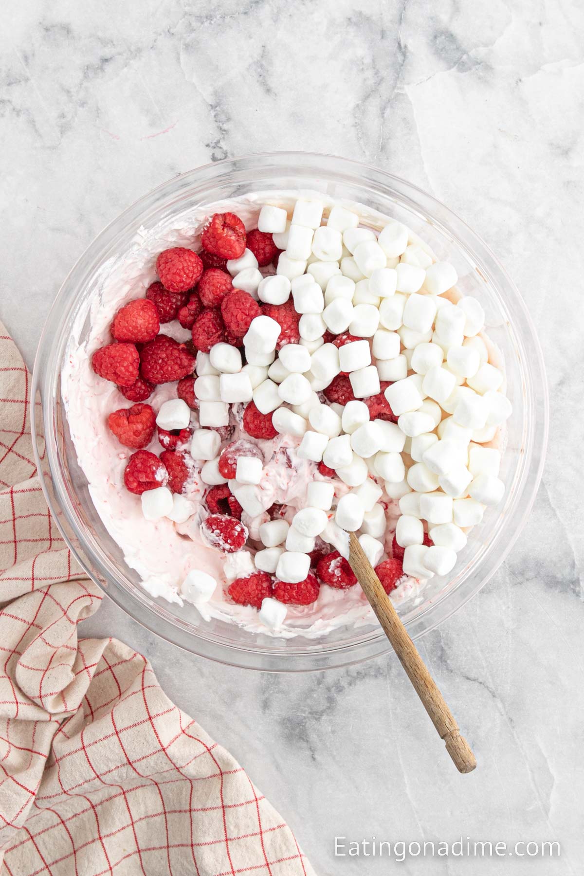 Stir in fresh raspberries and mini marshmallows into the jello mixture