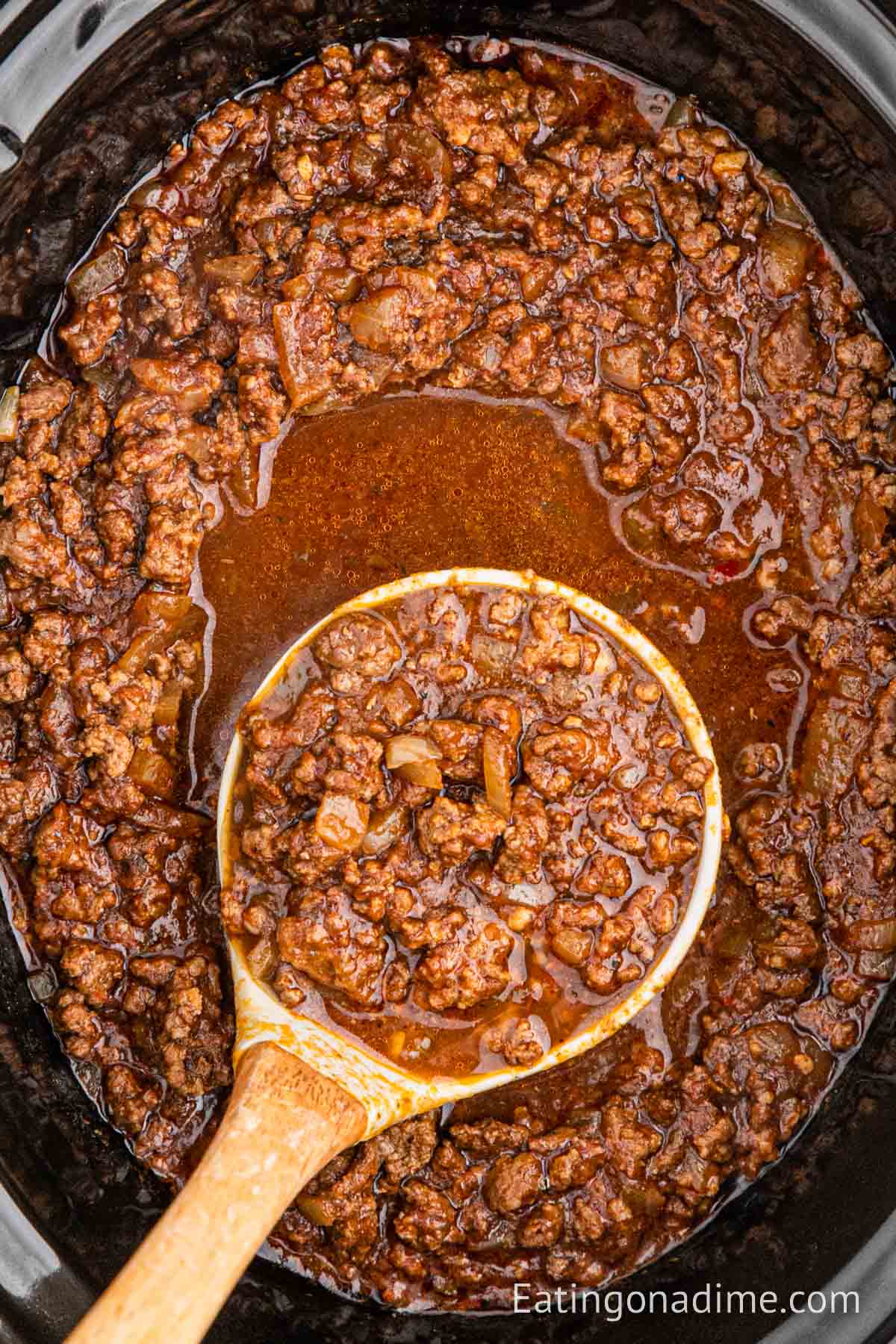 Cincinnati Chili in a slow cooker with a serving on a ladle