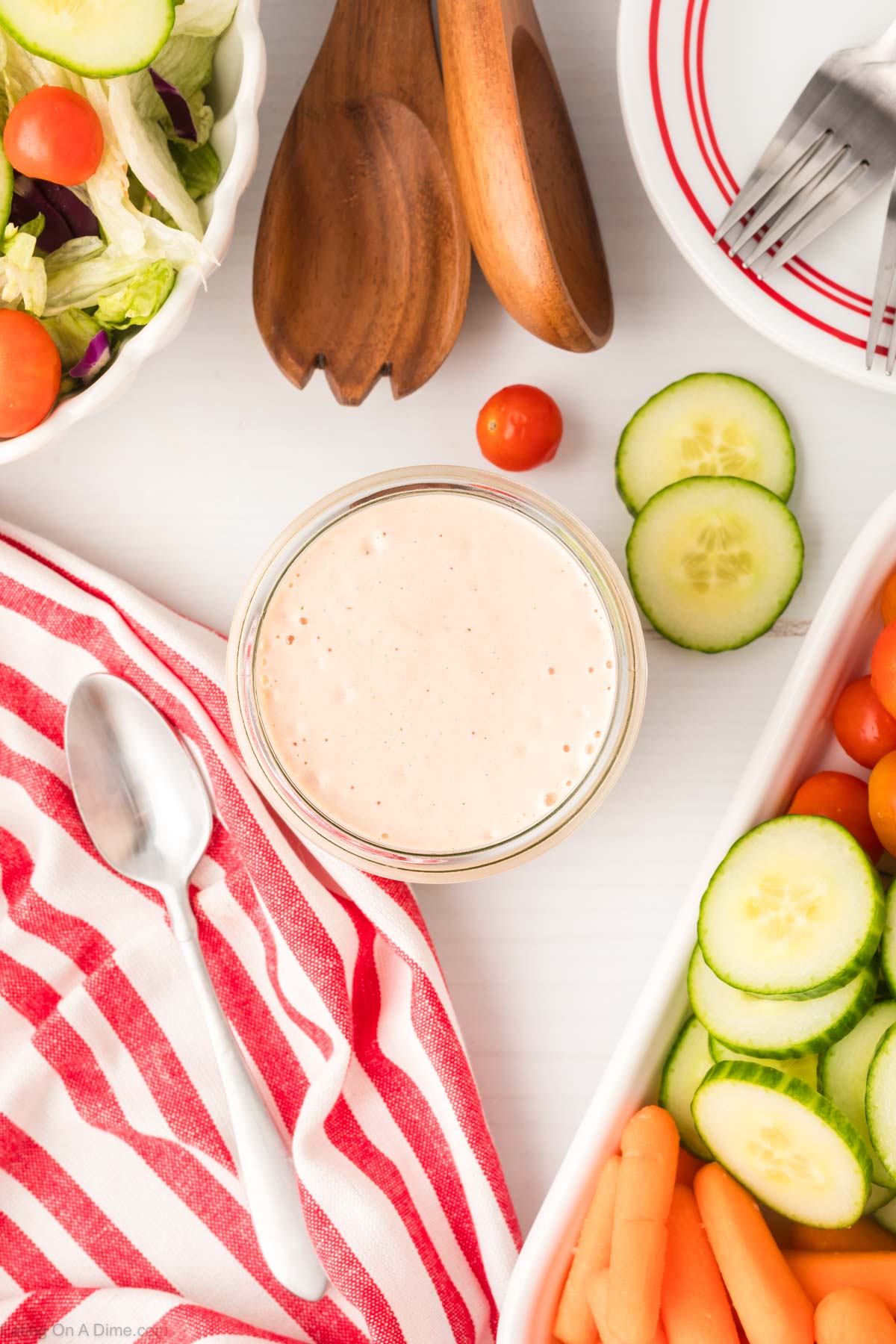 Salsa Ranch Dressing in a jar. Side salad in a bowl is on the side