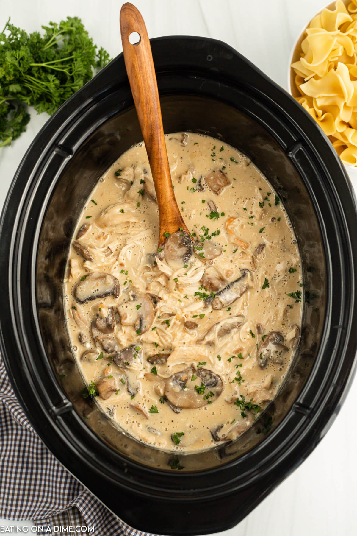 Chicken Stroganoff in the slow cooker with the wooden spoon