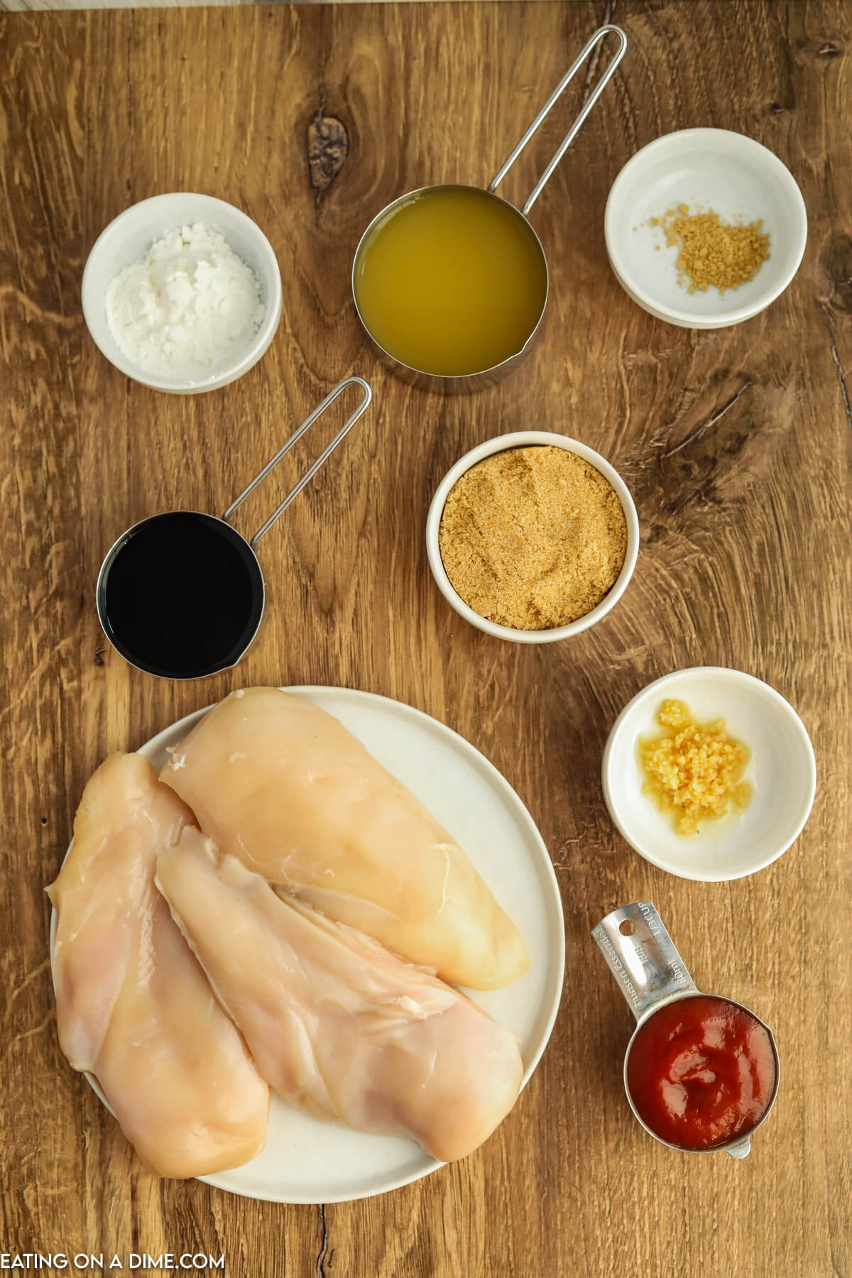 Ingredients for huli huli chicken - chicken breasts, pineapple juice, soy sauce, brown sugar, ketchup, ginger, minced garlic, cornstarch, cold water, green onions, sesame seeds