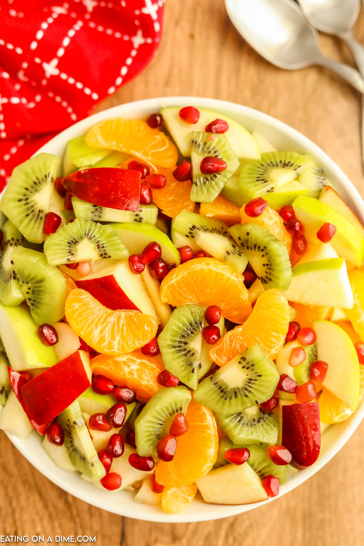 Winter fruit salad combined in a white serving bowl. 