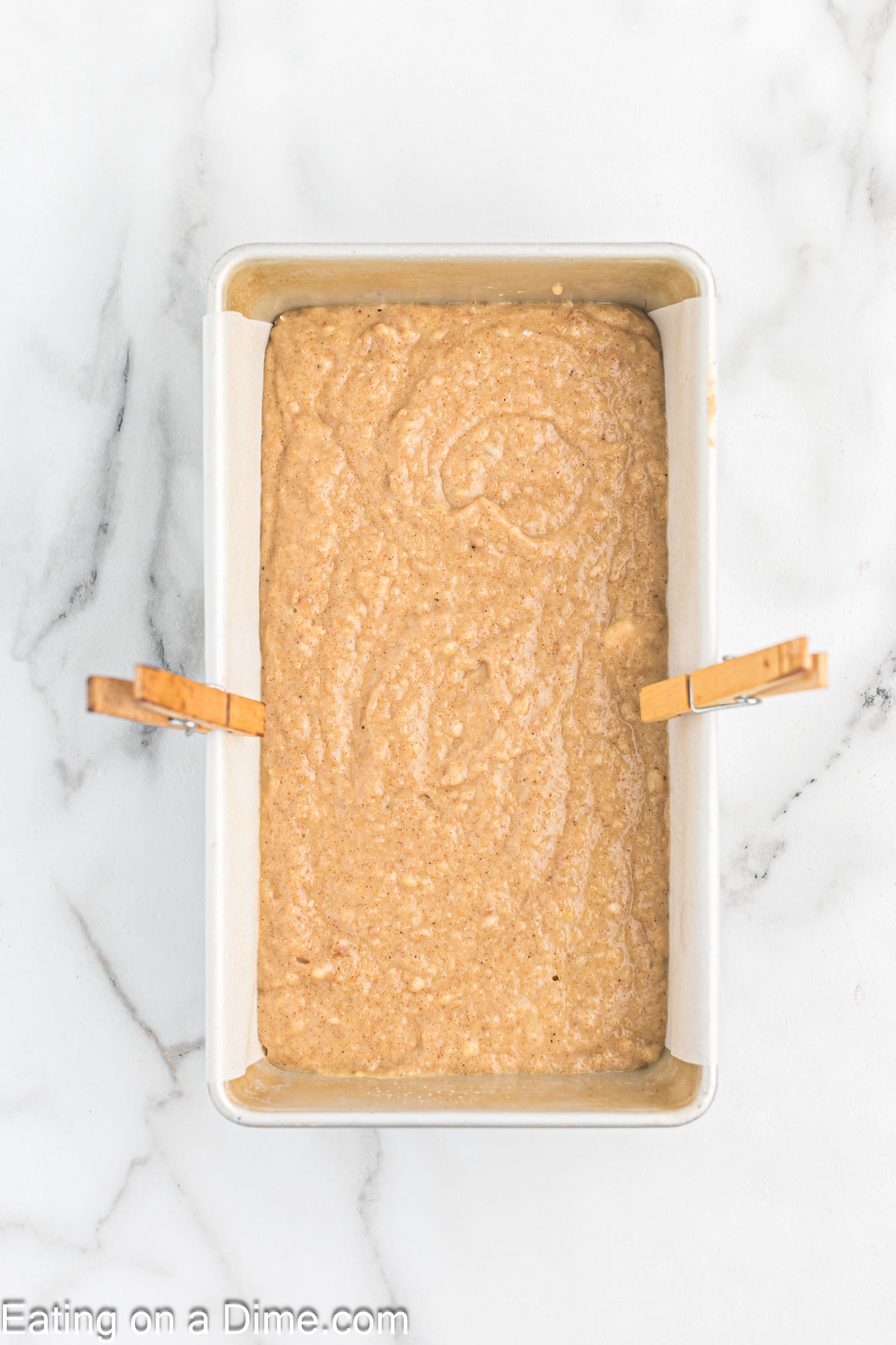Pouring the applesauce batter into prepared loaf pan