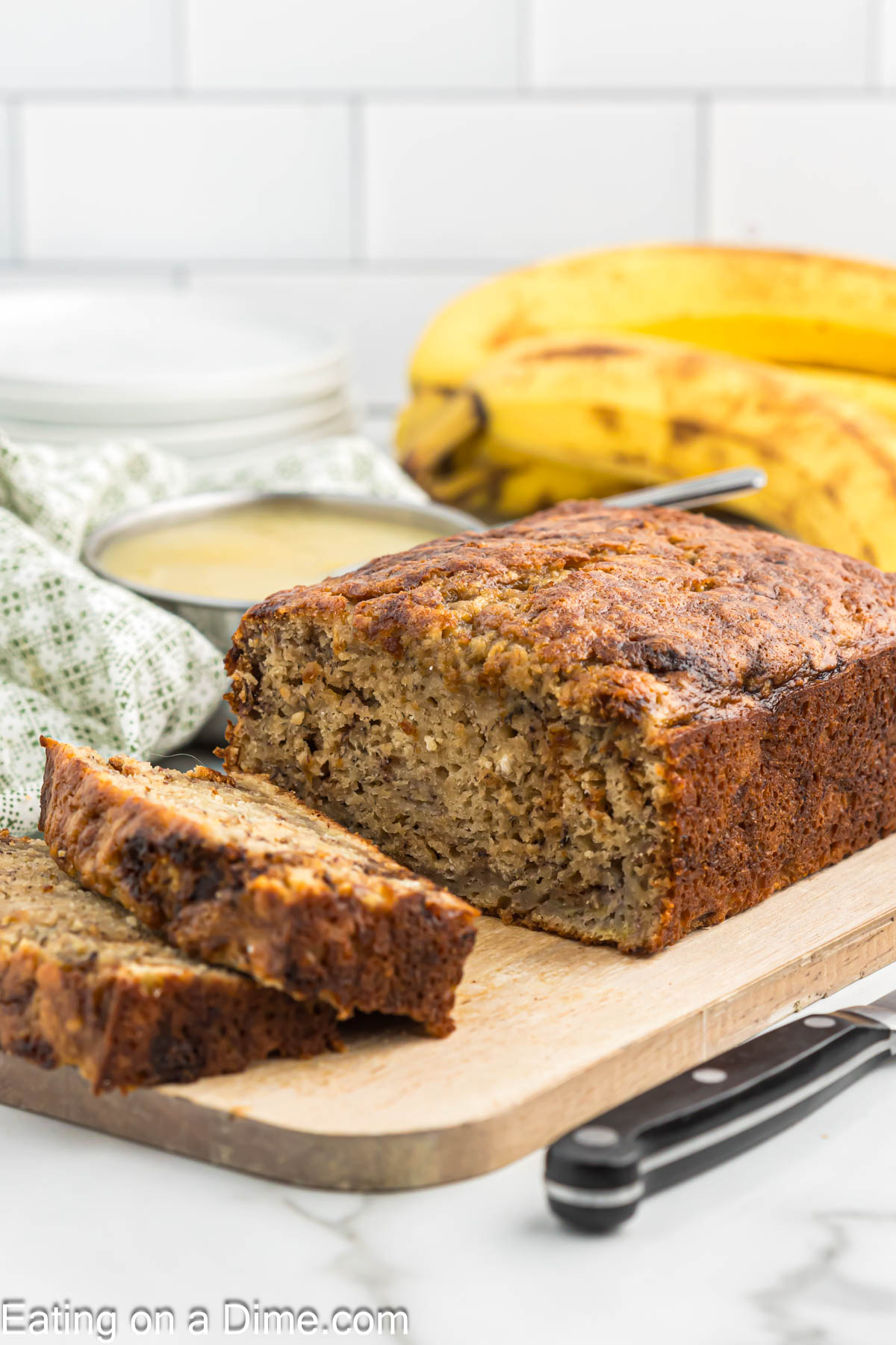 Banana Bread with Applesauce sliced on a cutting board