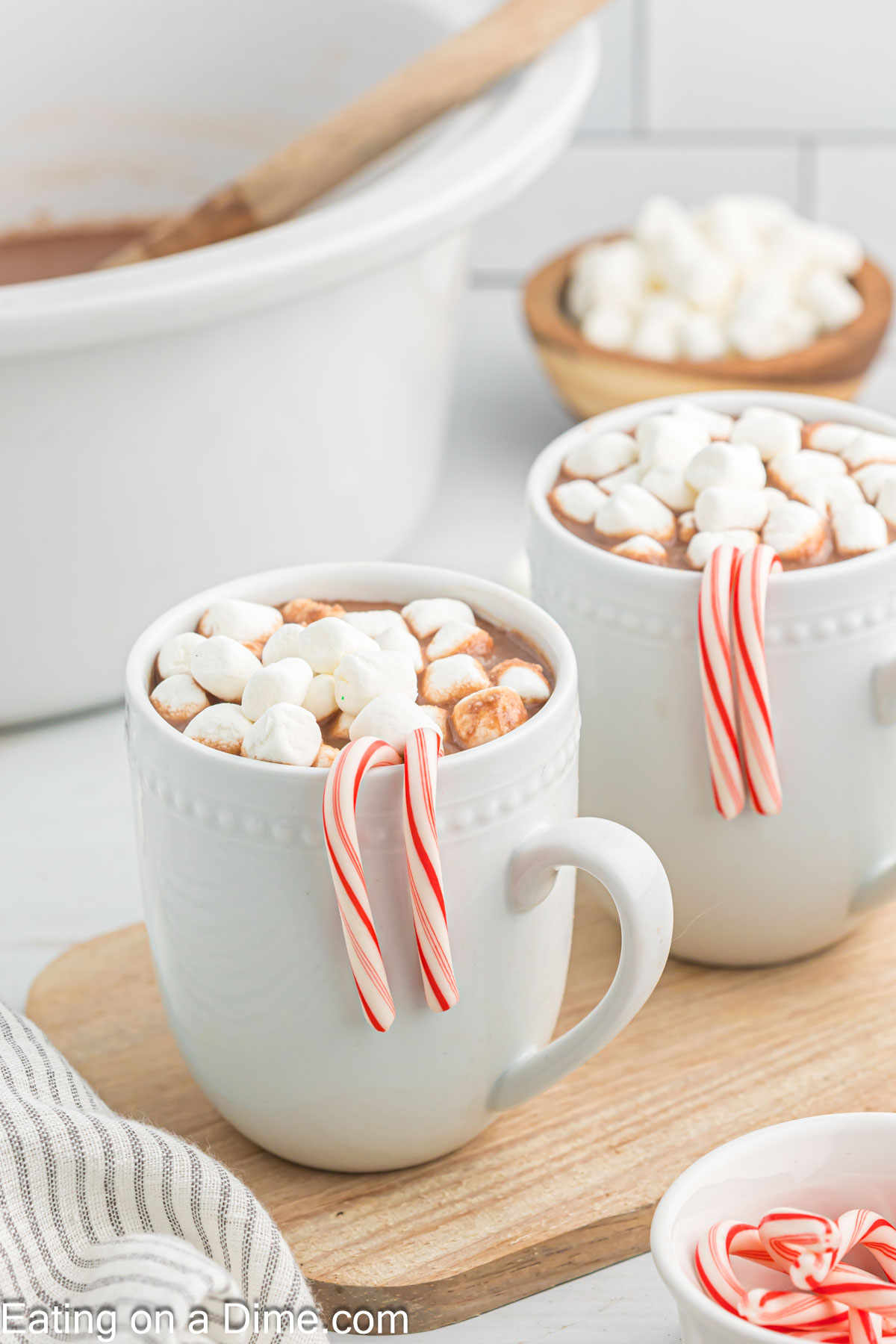 Hot Chocolate in mugs topped with marshmallows and candy canes