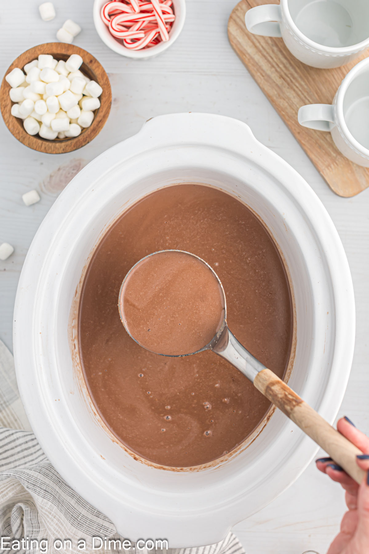 Hot Chocolate in the slow cooker with a serving on a ladle