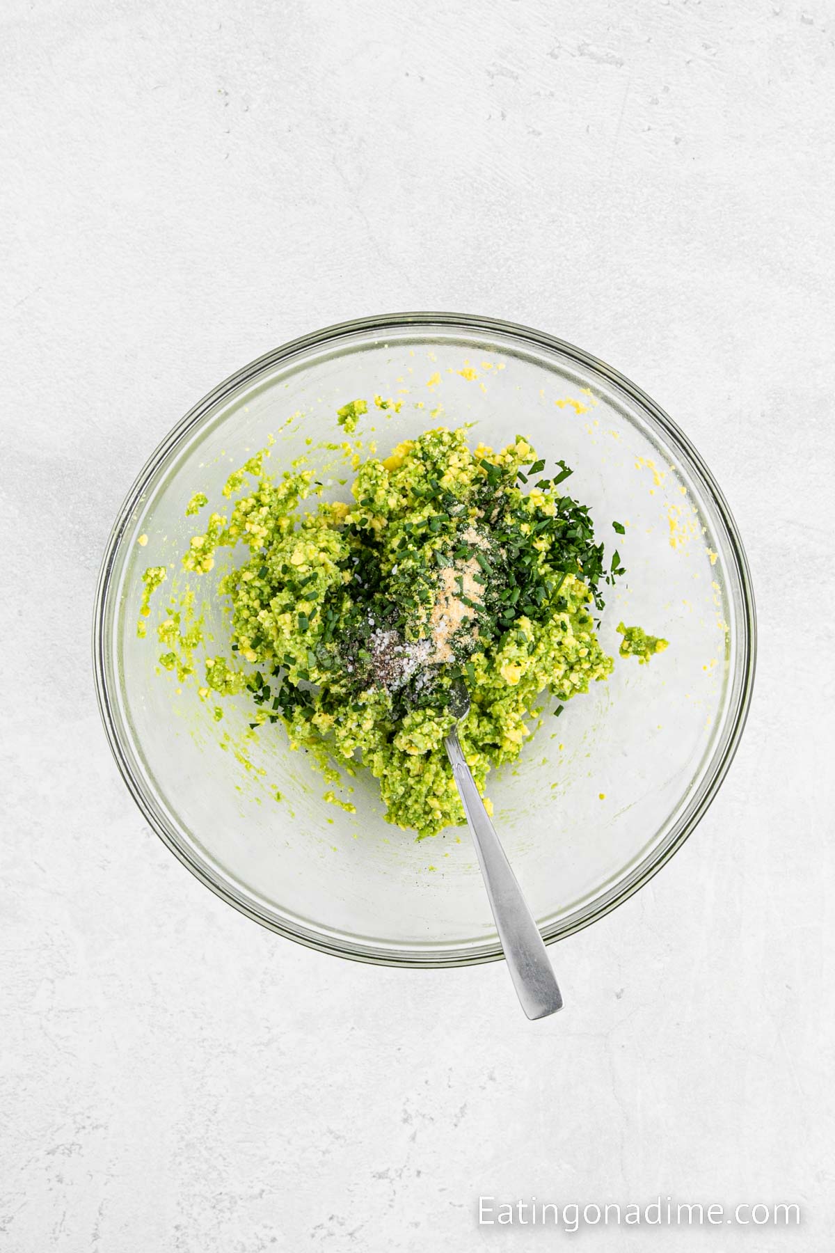 Mixing in the cilantro, chives, salt and pepper into the avocado mixture