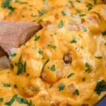 A pan with cheese and potatoes.