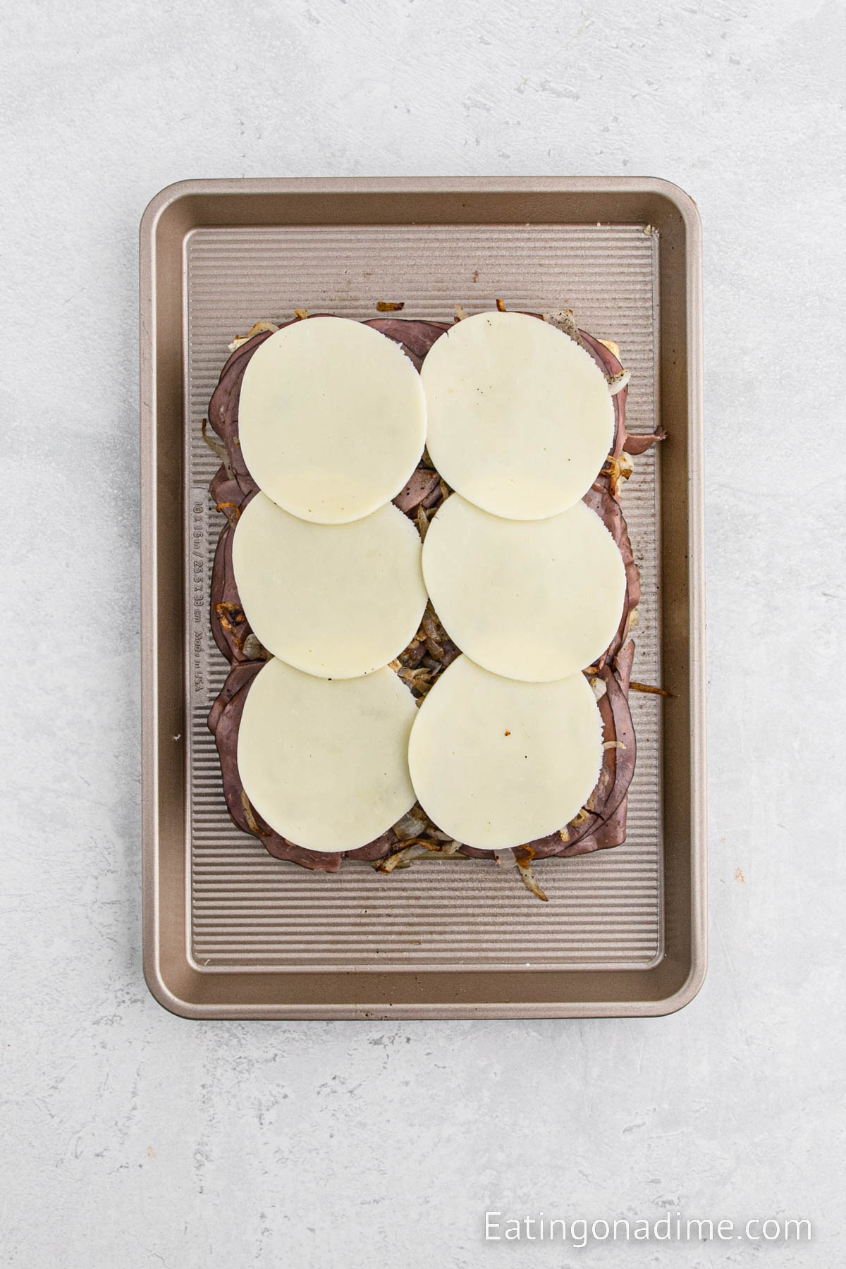 Layering cheese on the sliders