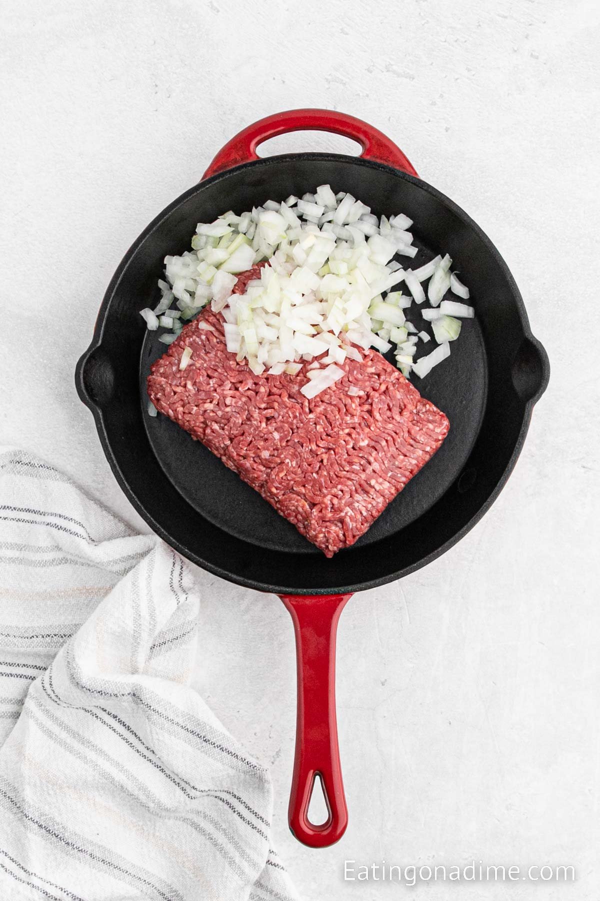 Frying the beef and onions together in the skillet