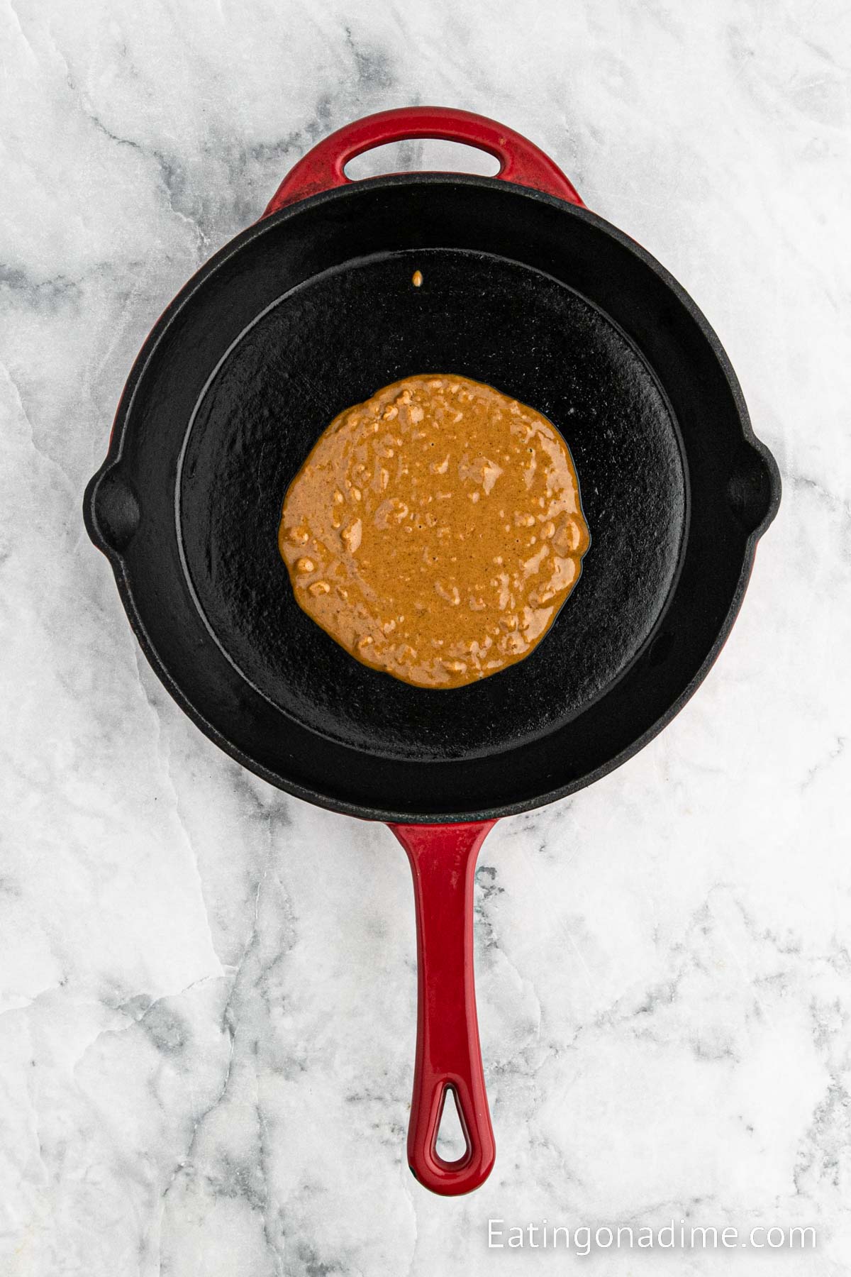 Cooking gingerbread pancake batter in a cast iron skillet