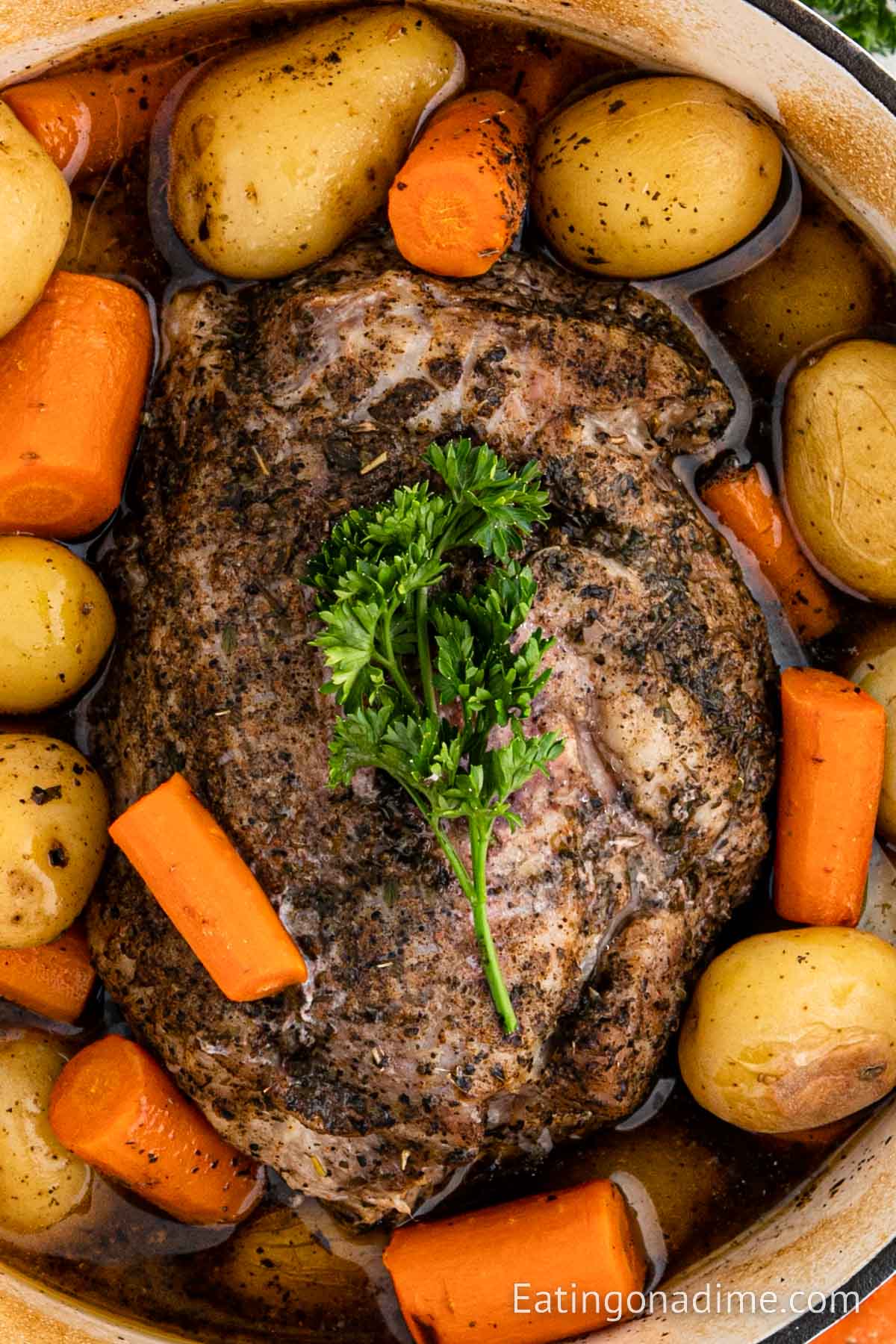 Close up image of pork roast with carrots and potatoes