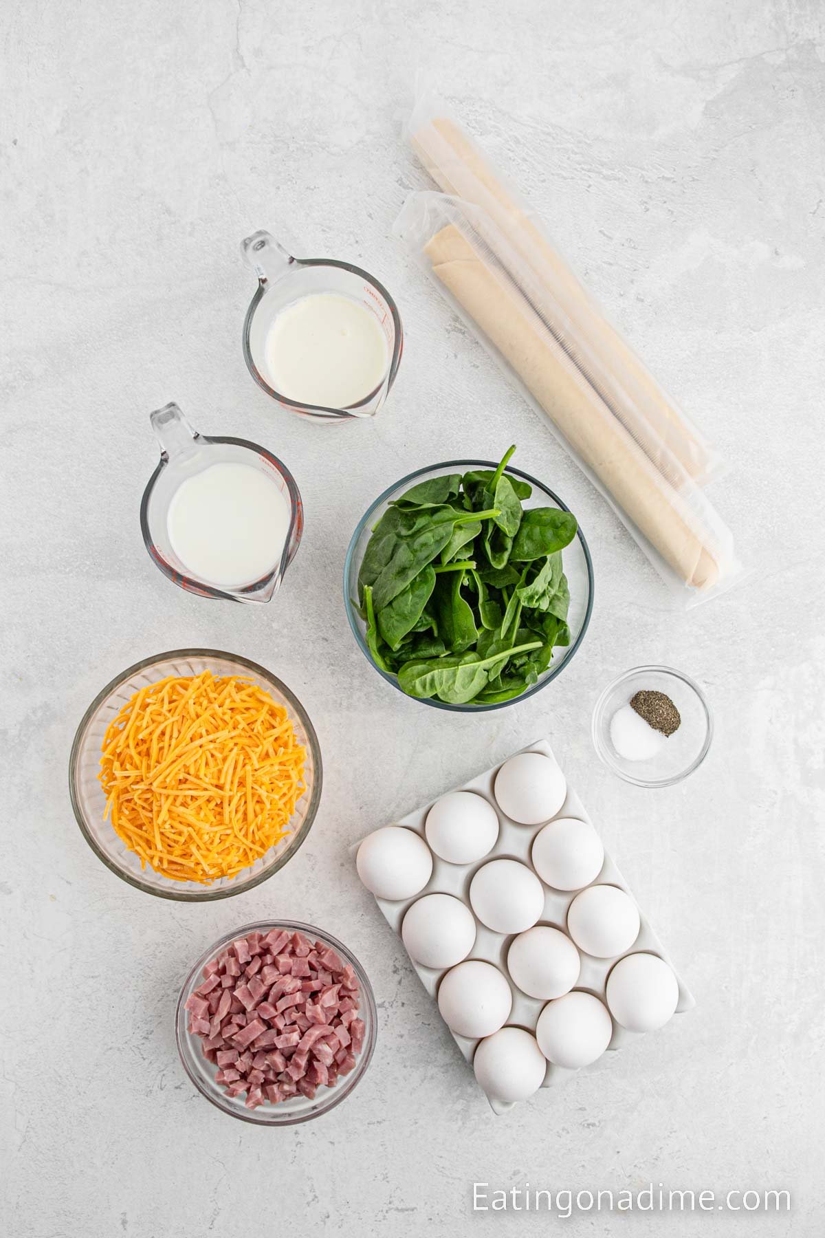 Quiche Muffins Ingredients - pie crusts, eggs, spinach, milk, heavy cream, salt, pepper, ham, cheese