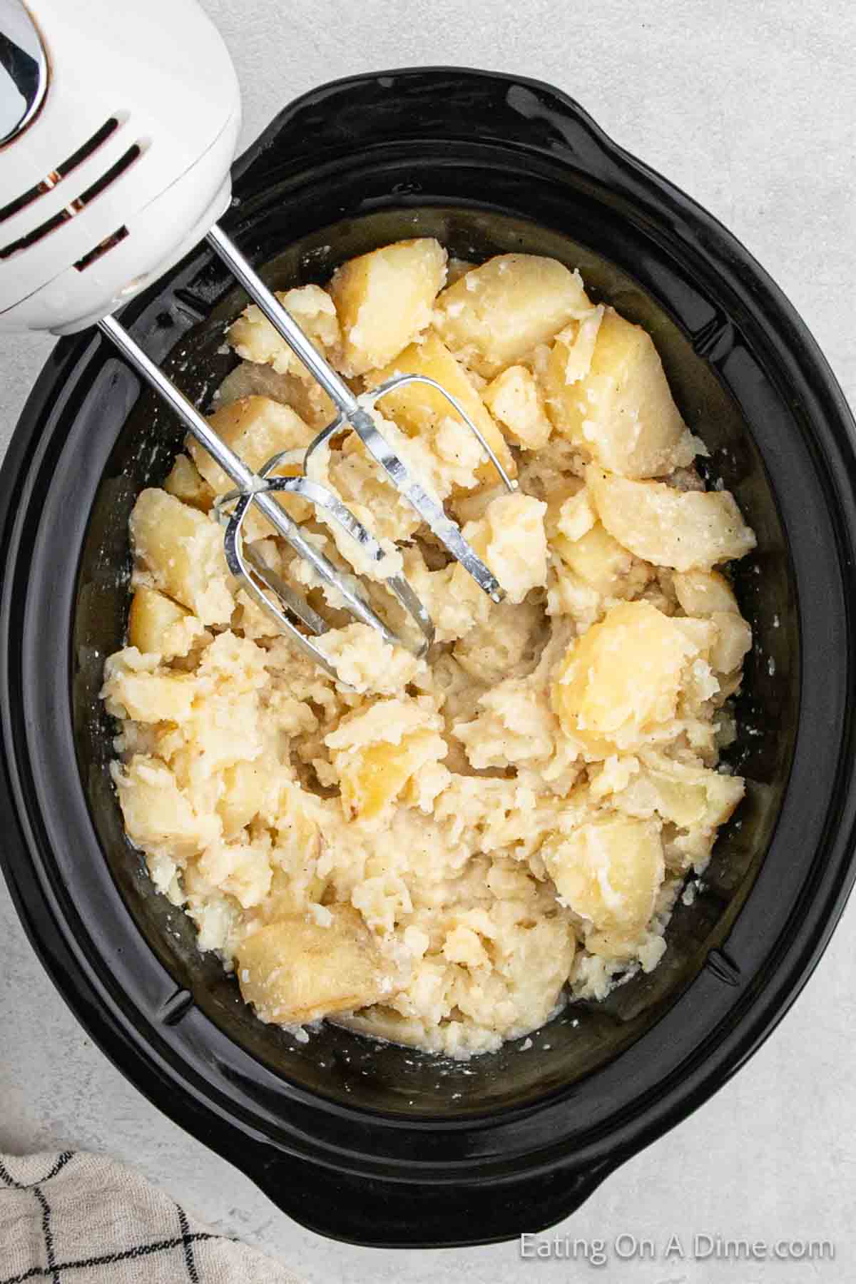 Mash potatoes in the slow cooker with a hand mixer