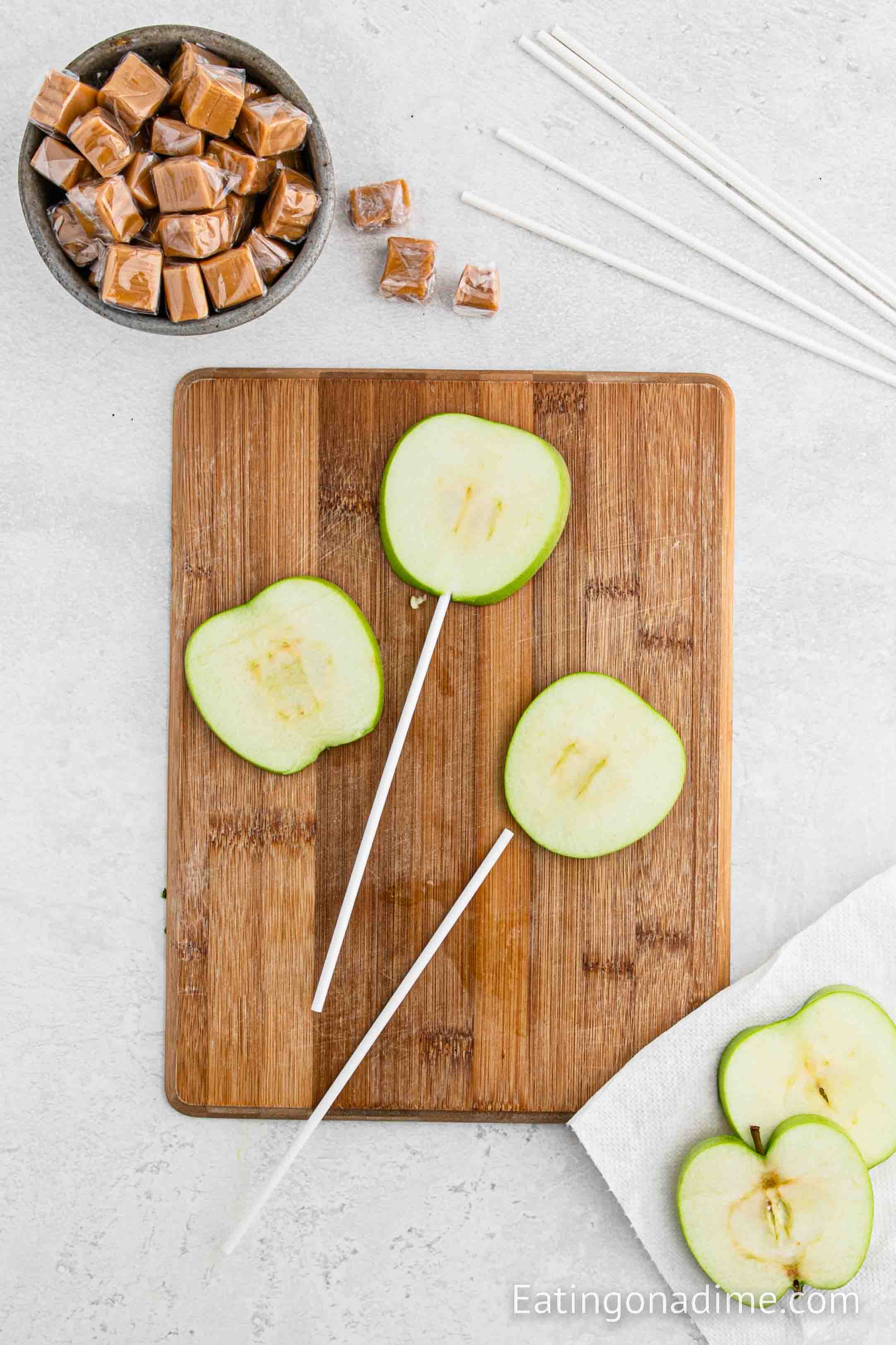 Inserting apple slices with sticks