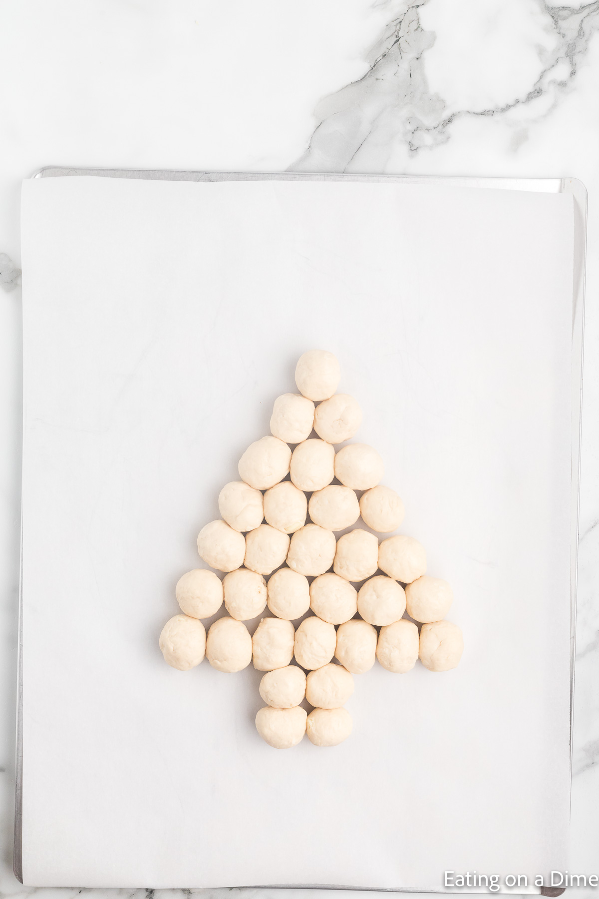 Placing the dough on a baking sheet in shape of a Christmas Tree