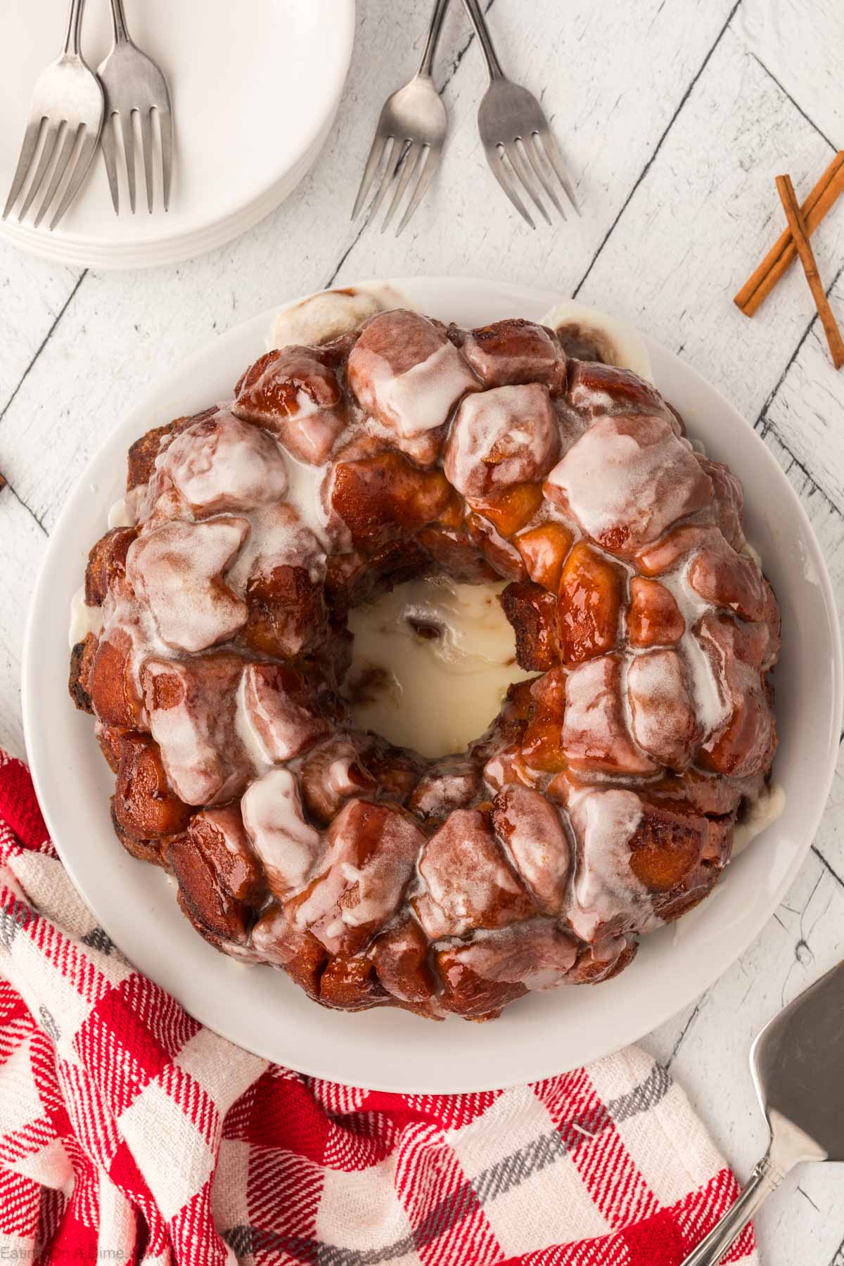 Close up image of cinnamon roll monkey bread on a white plate