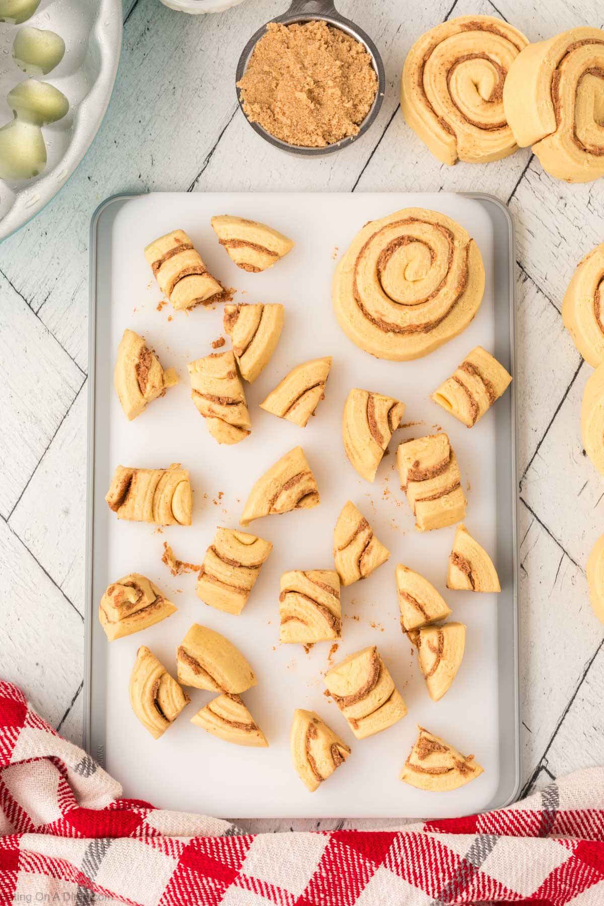 Dicing up the cinnamon rolls on a cutting board