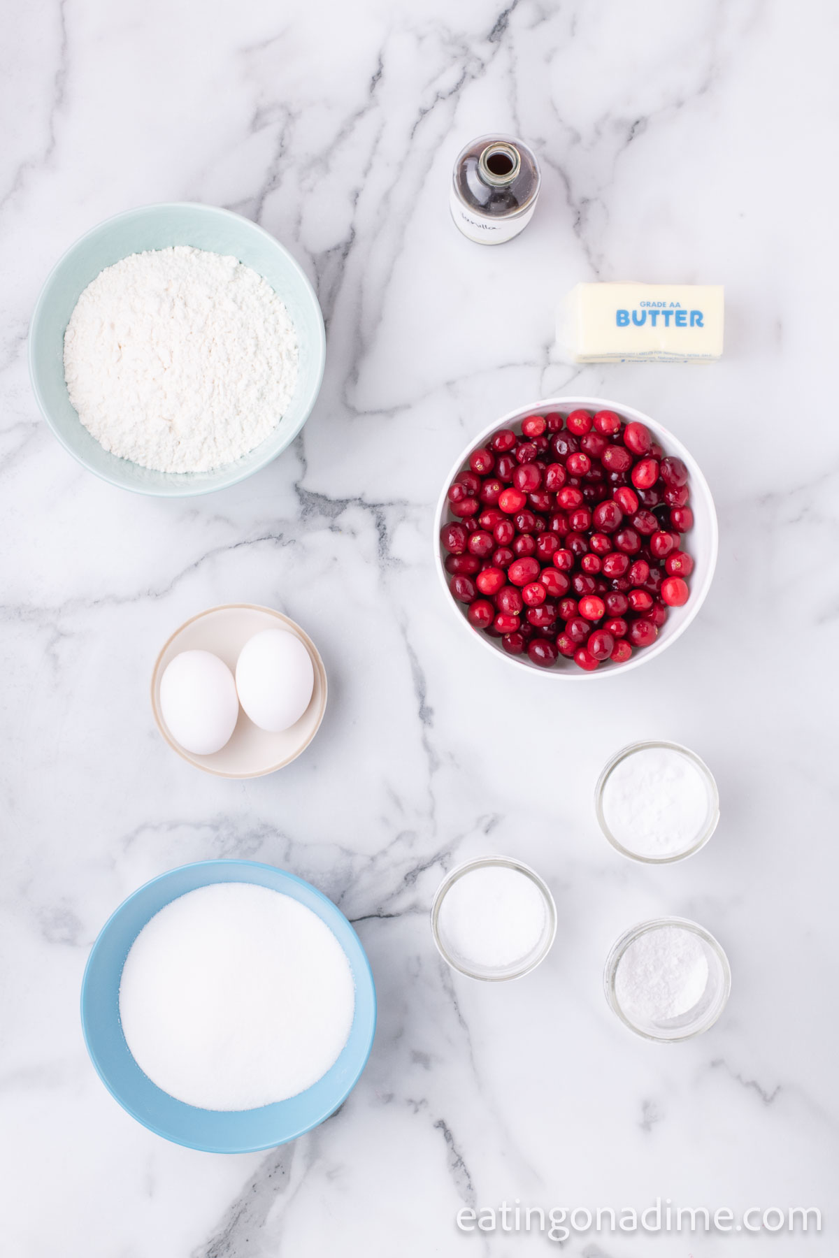 Ingredients for cranberry bread - flour, cranberries, butter, eggs, sugar, baking powder. 