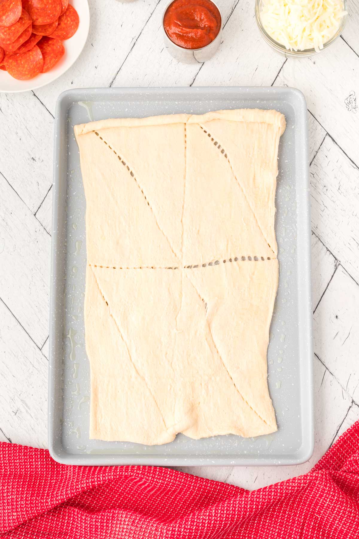 Crescent roll rolled out on a baking sheet