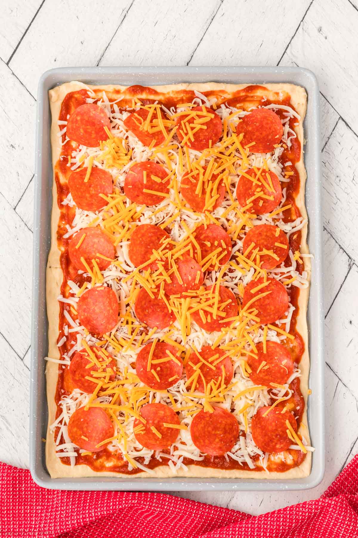 Topping with shredded cheese