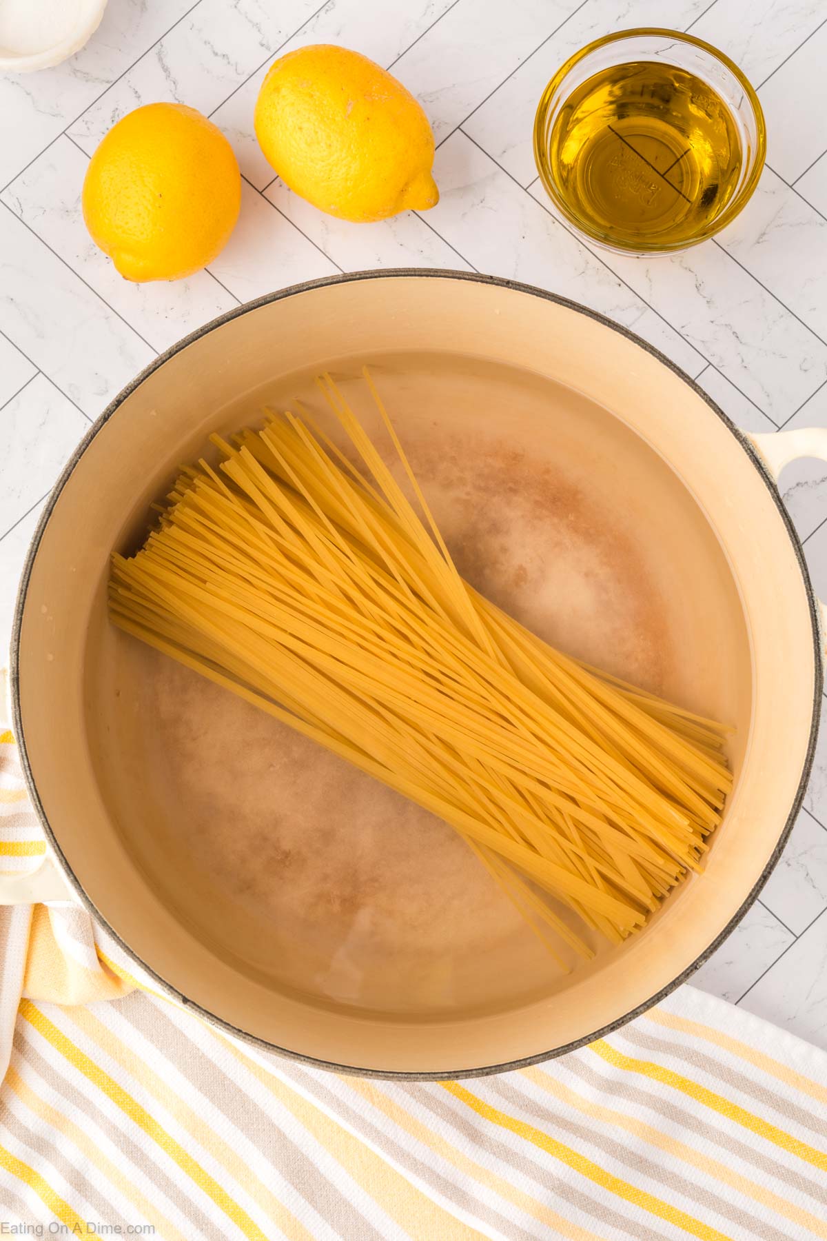 Placing spaghetti noodles in a large pot of water