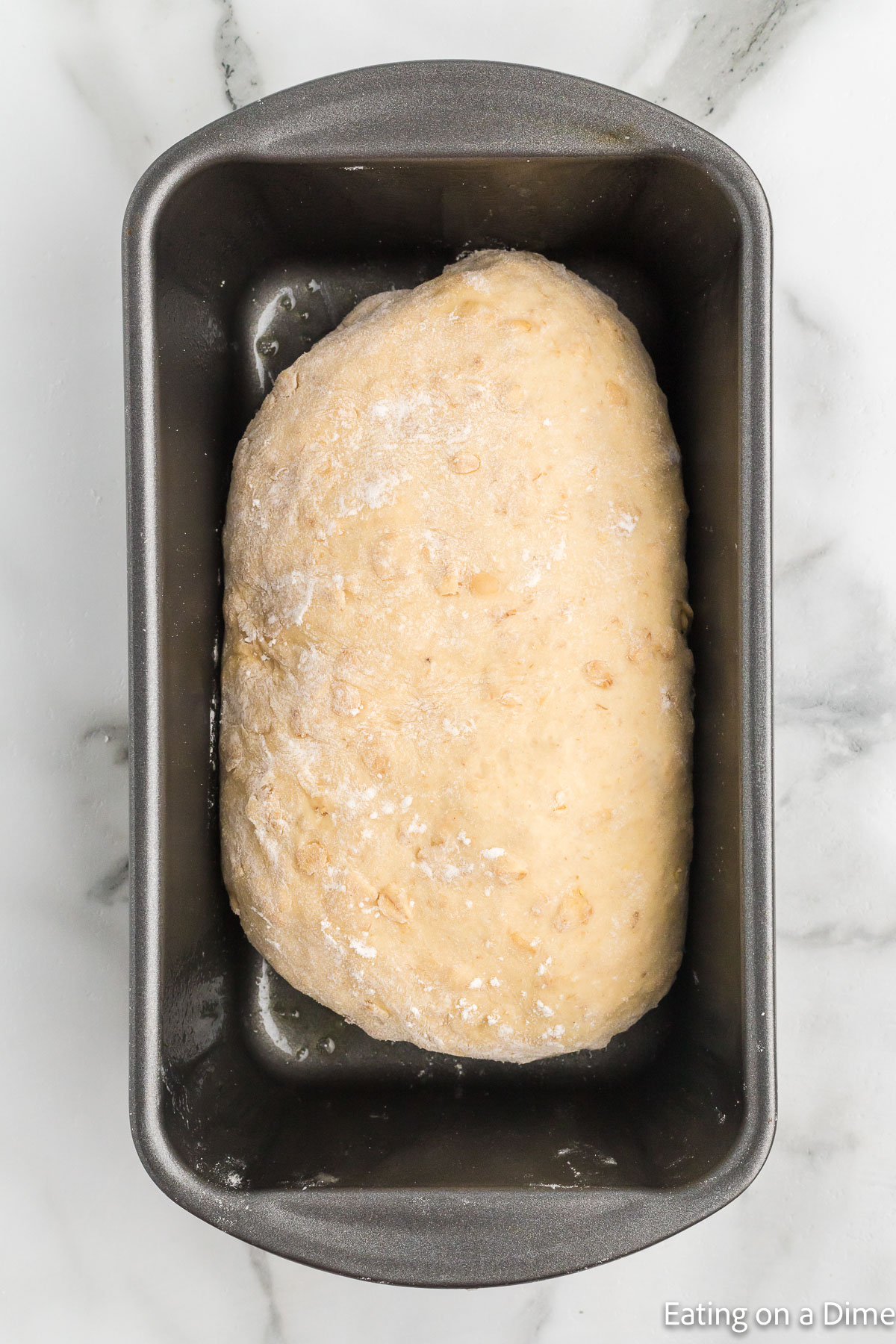 Dough shaped into a loaf in a loaf pan
