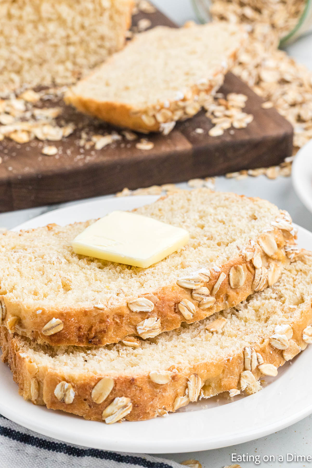 Sliced oatmeal bread topped with butter
