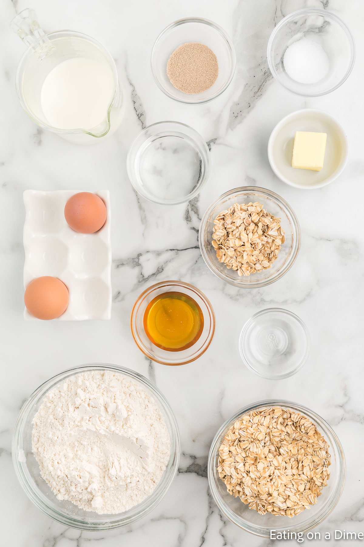 Oatmeal Bread ingredients - rolled oats, butter, milk, warm water, active dry yeast, flour, honey, salt, egg
