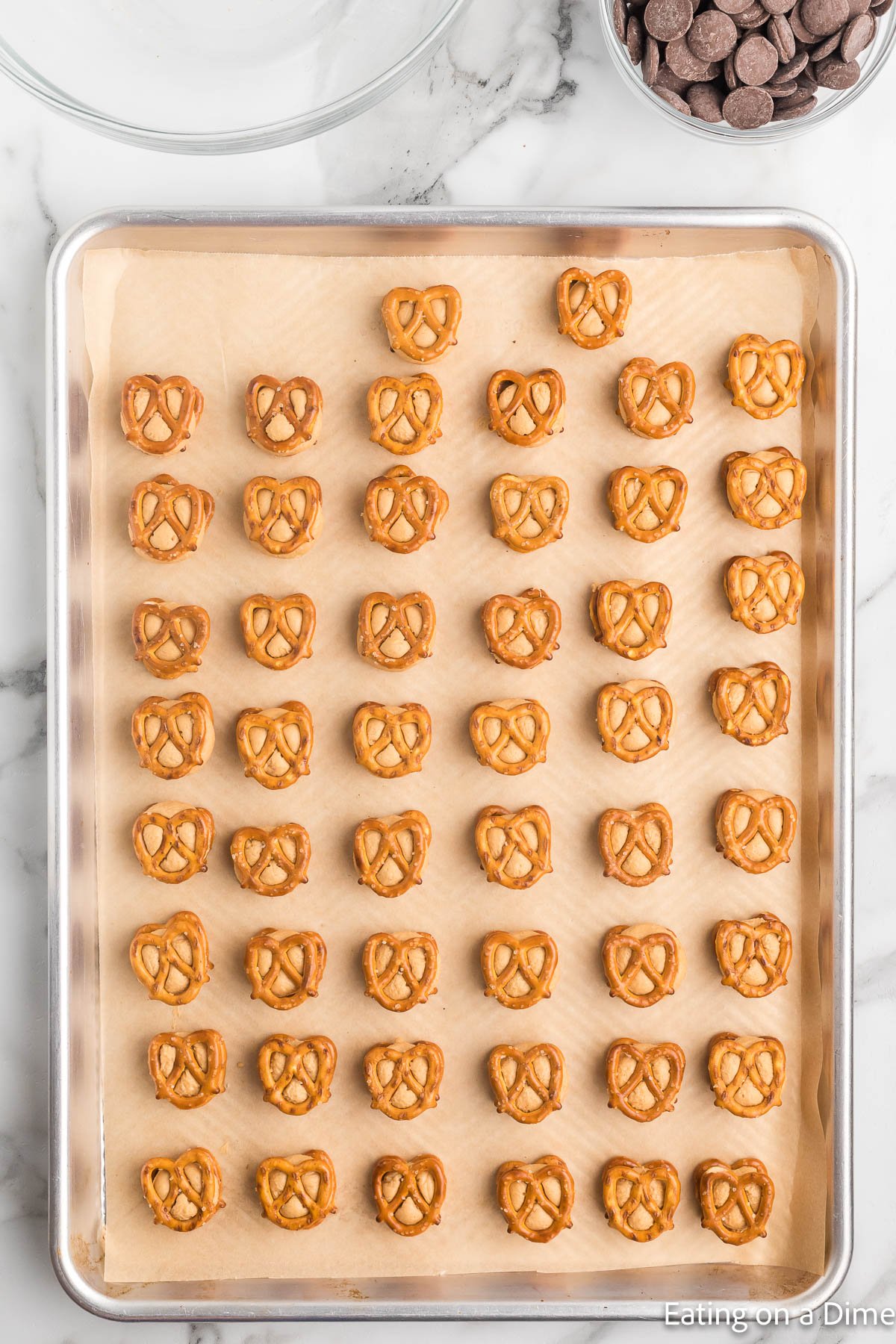 Pressing the pretzels onto the peanut butter ball