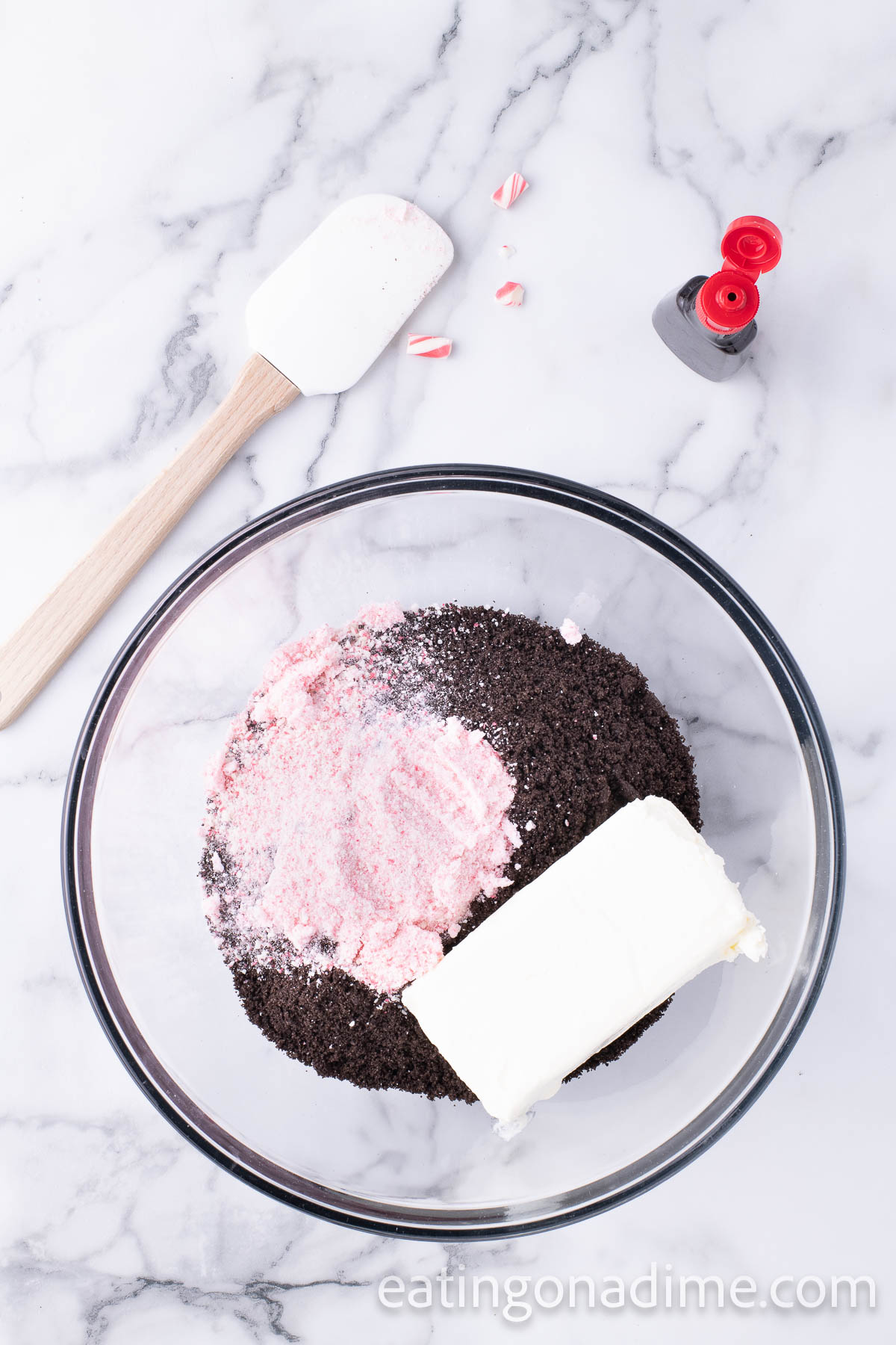Combining the crushed candy canes and cream cheese and crushed Oreos