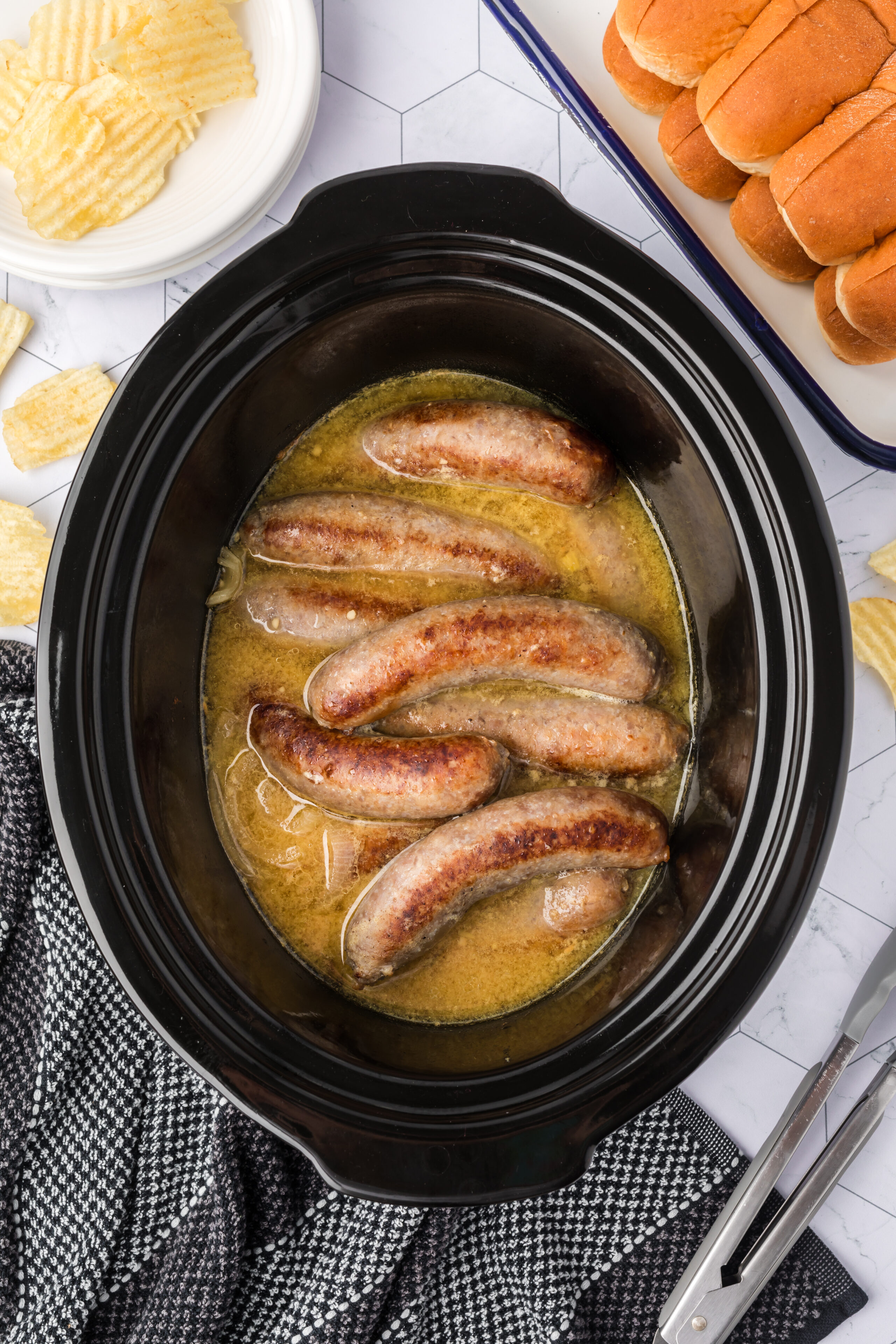 Cooked brats in the slow cooker