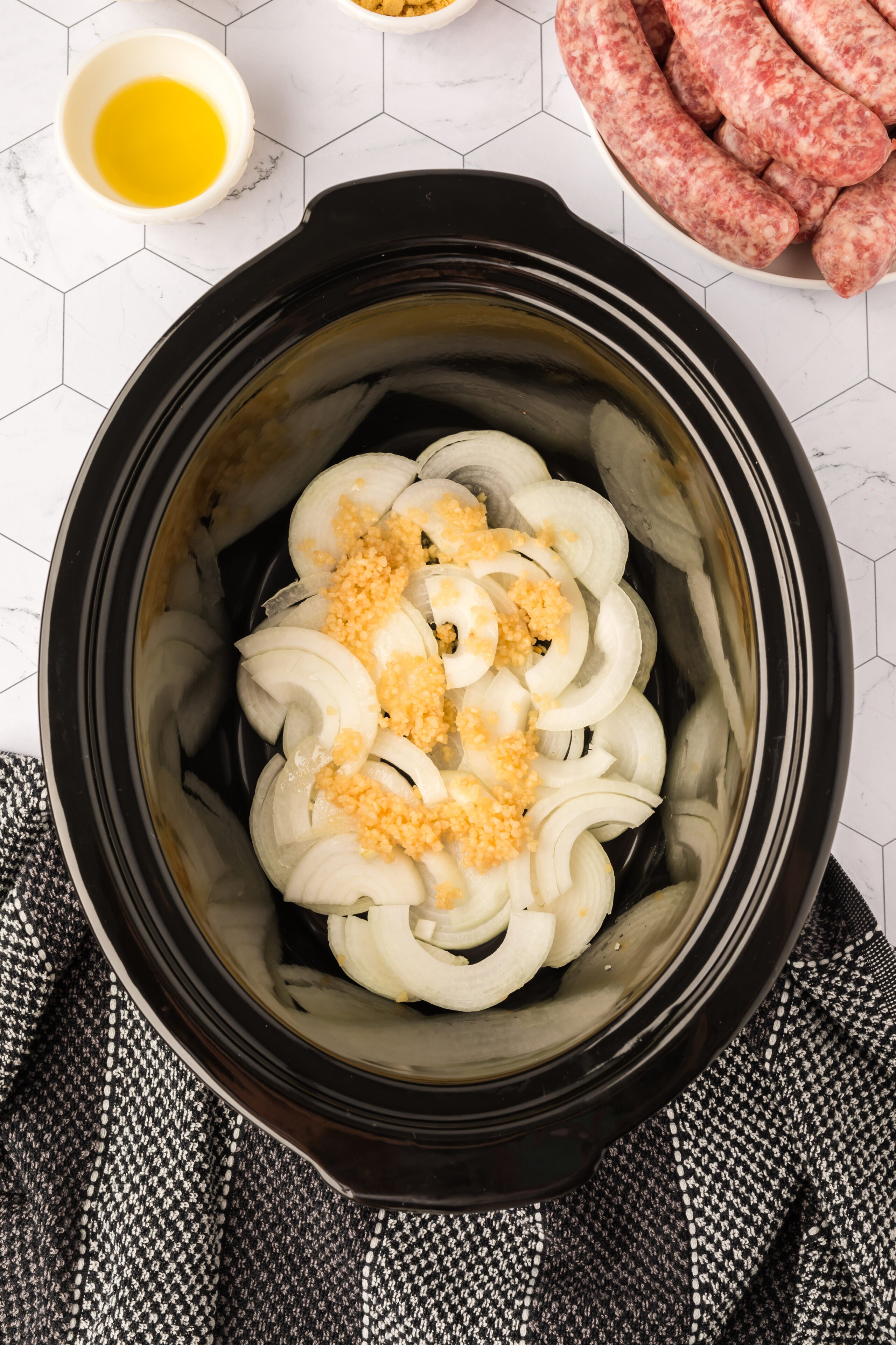 Placing the onions and garlic in the slow cooker