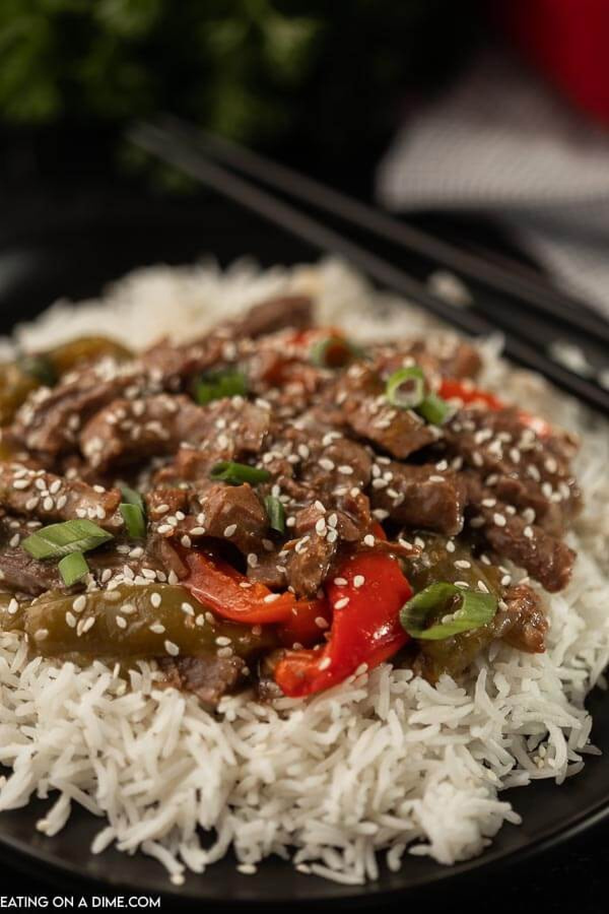 Pepper Steak on white rice on a plate