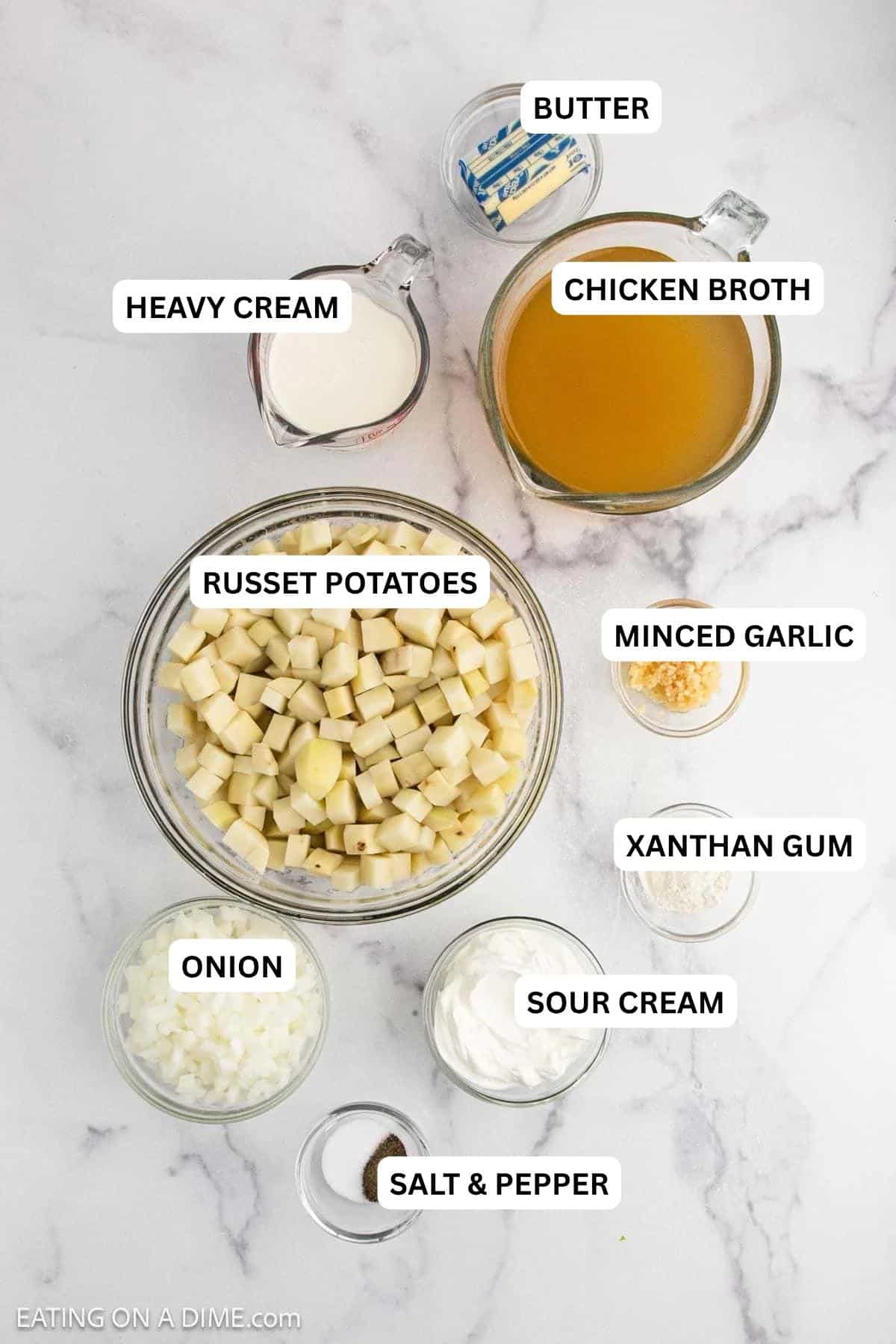 Ingredients for recipe - butter, heavy cream, chicken broth, minced garlic, russet potatoes, minced garlic, sour cream, onion, salt and pepper. 