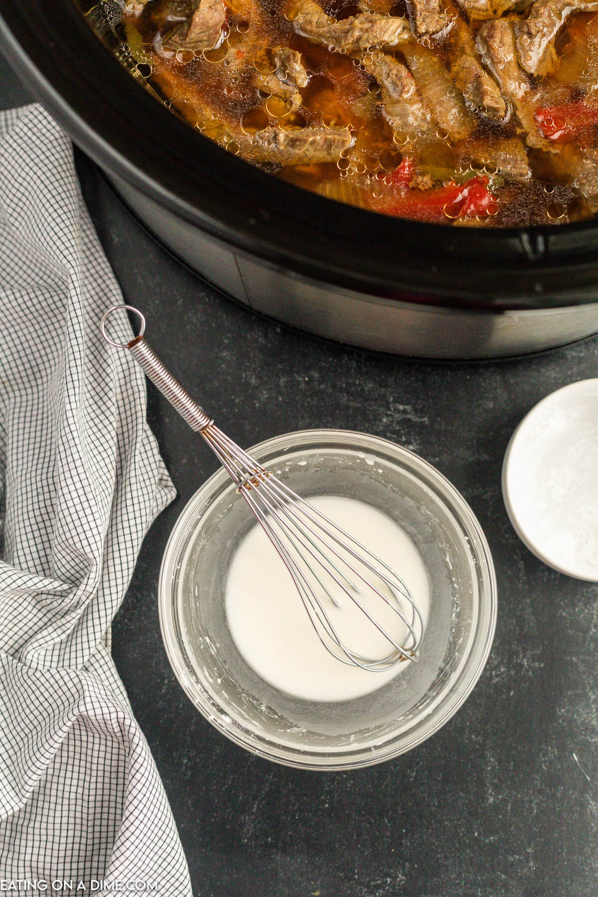 Cornstarch and cold water whisk together in a small bowl.  