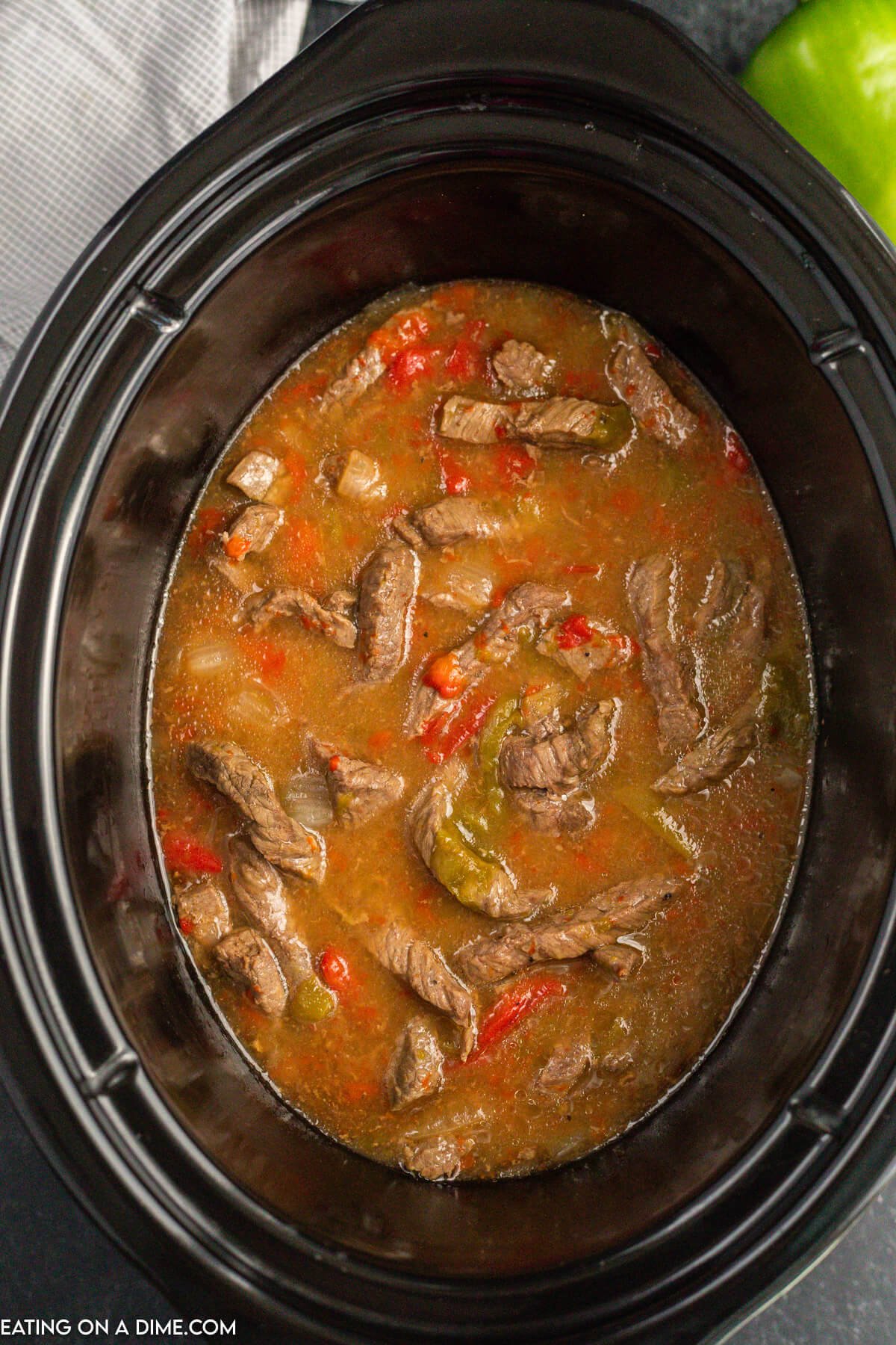 The sauce is in the crock pot thickened and mixed into the beef, peppers and onions.  