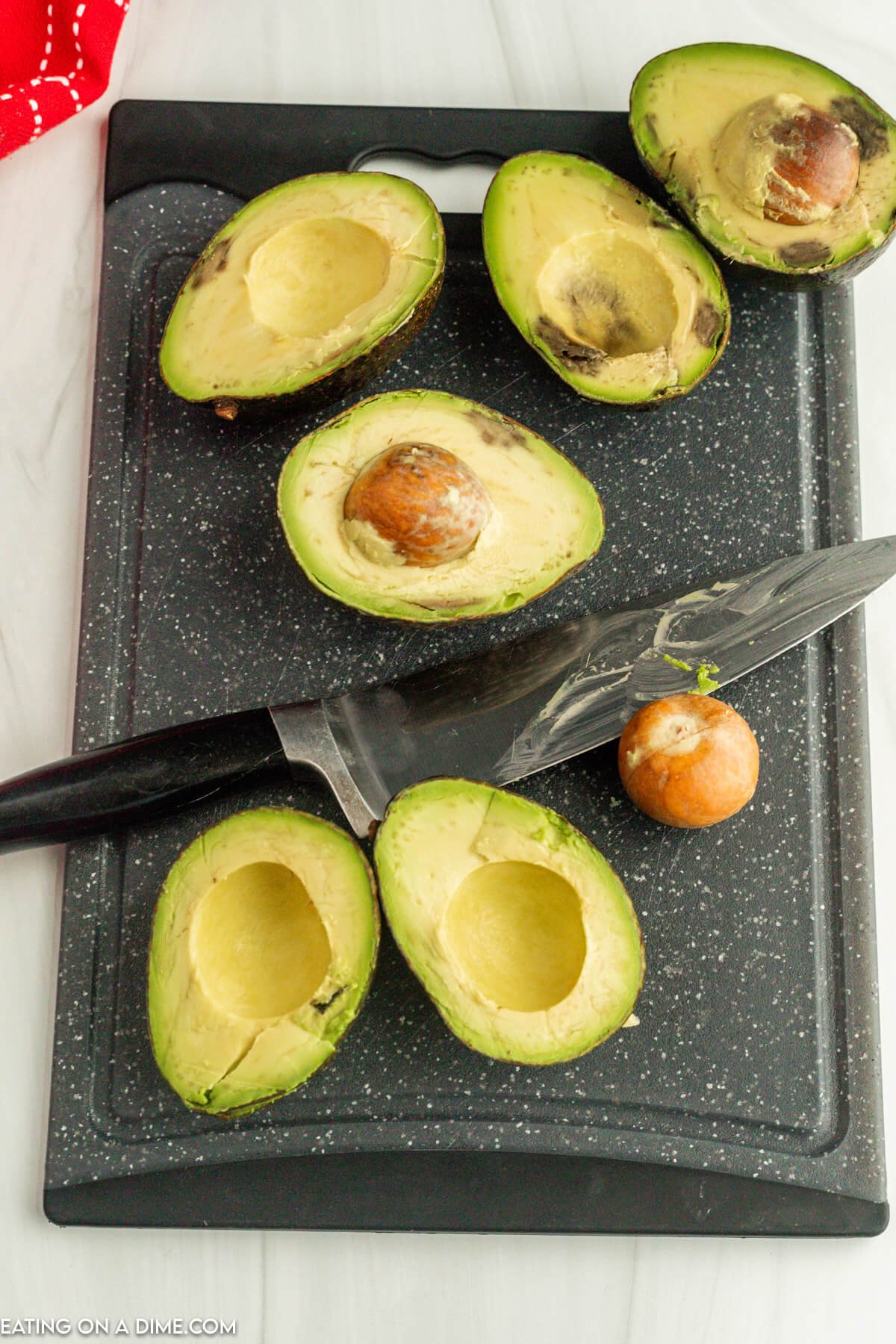 Cutting avocados in half with a knife