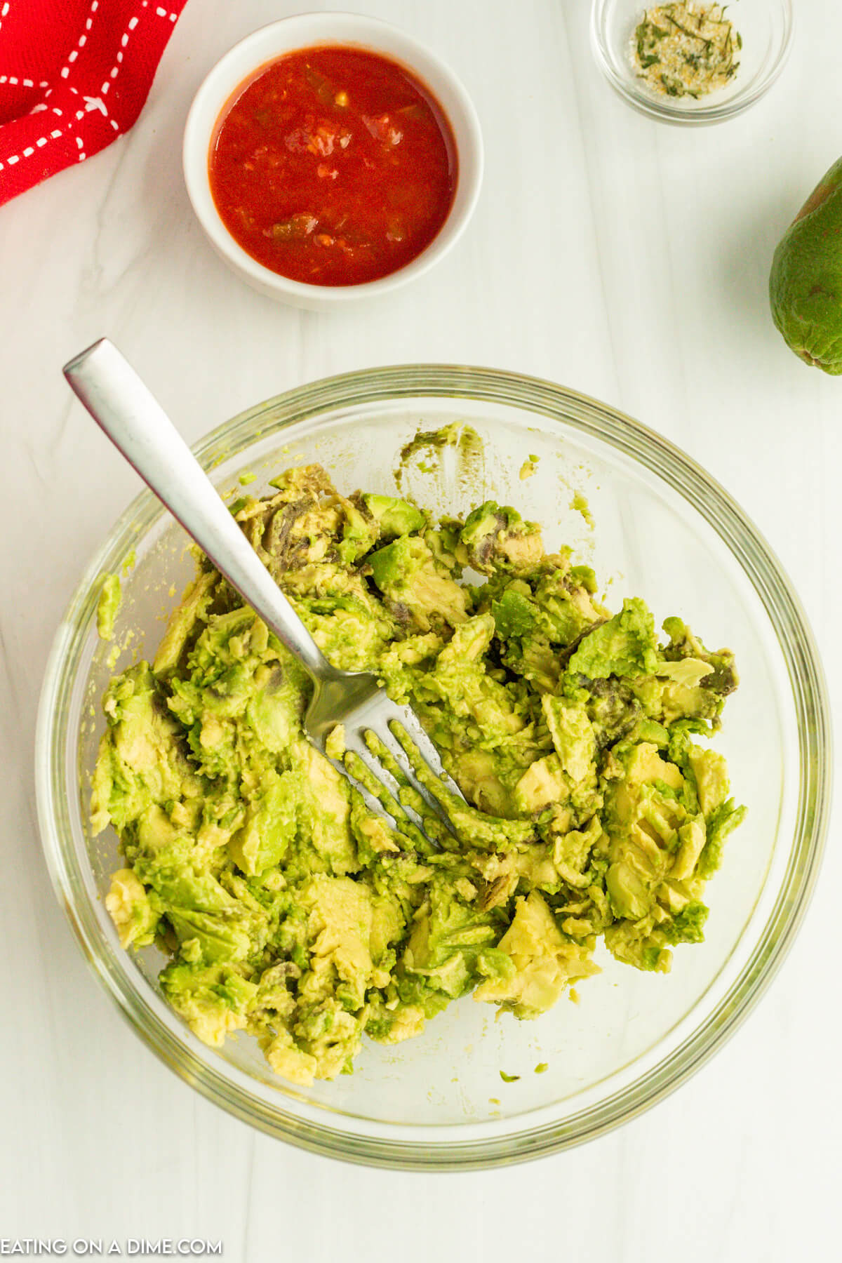 Mashing avocado in a bowl with a fork