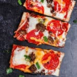 French bread pizza topped with pepperoni, veggies and melted cheese.