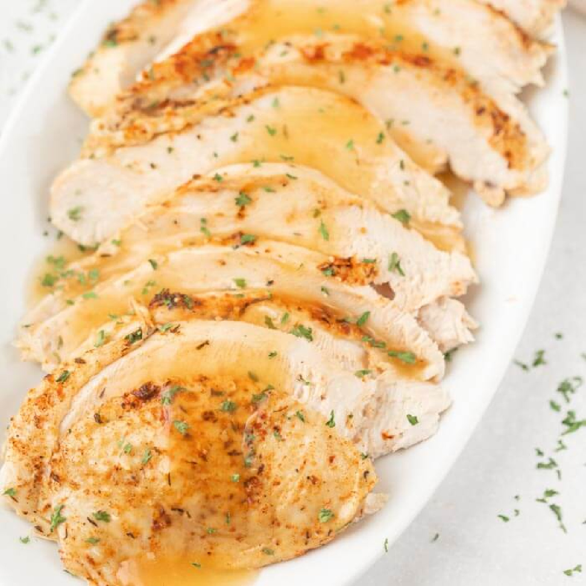 sliced turkey breast with gravy on platter