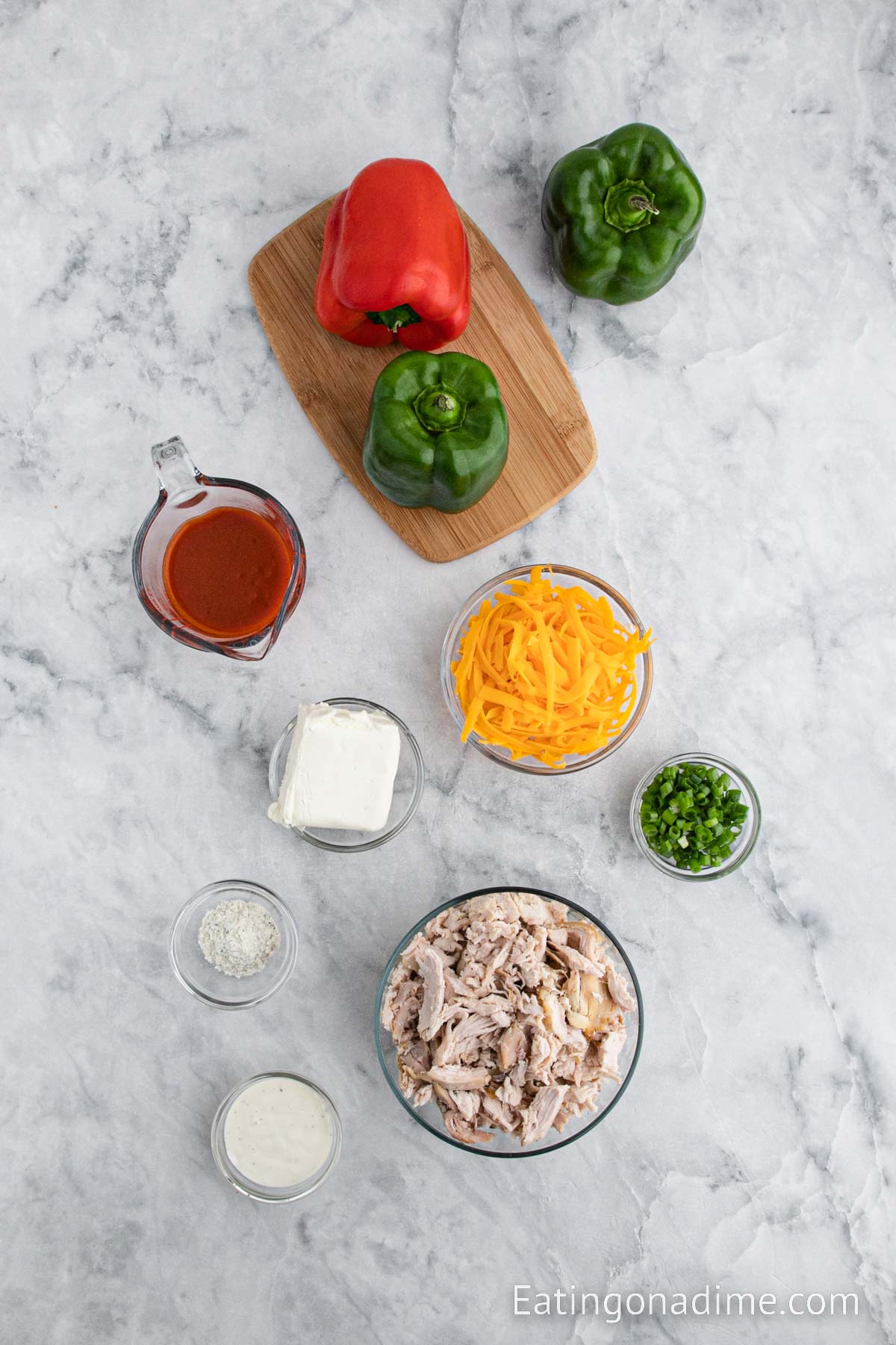 Buffalo Chicken Stuffed Peppers ingredients - bell peppers, shredded chicken, cream cheese, buffalo sauce, ranch seasoning mix, green onions, ranch dressing