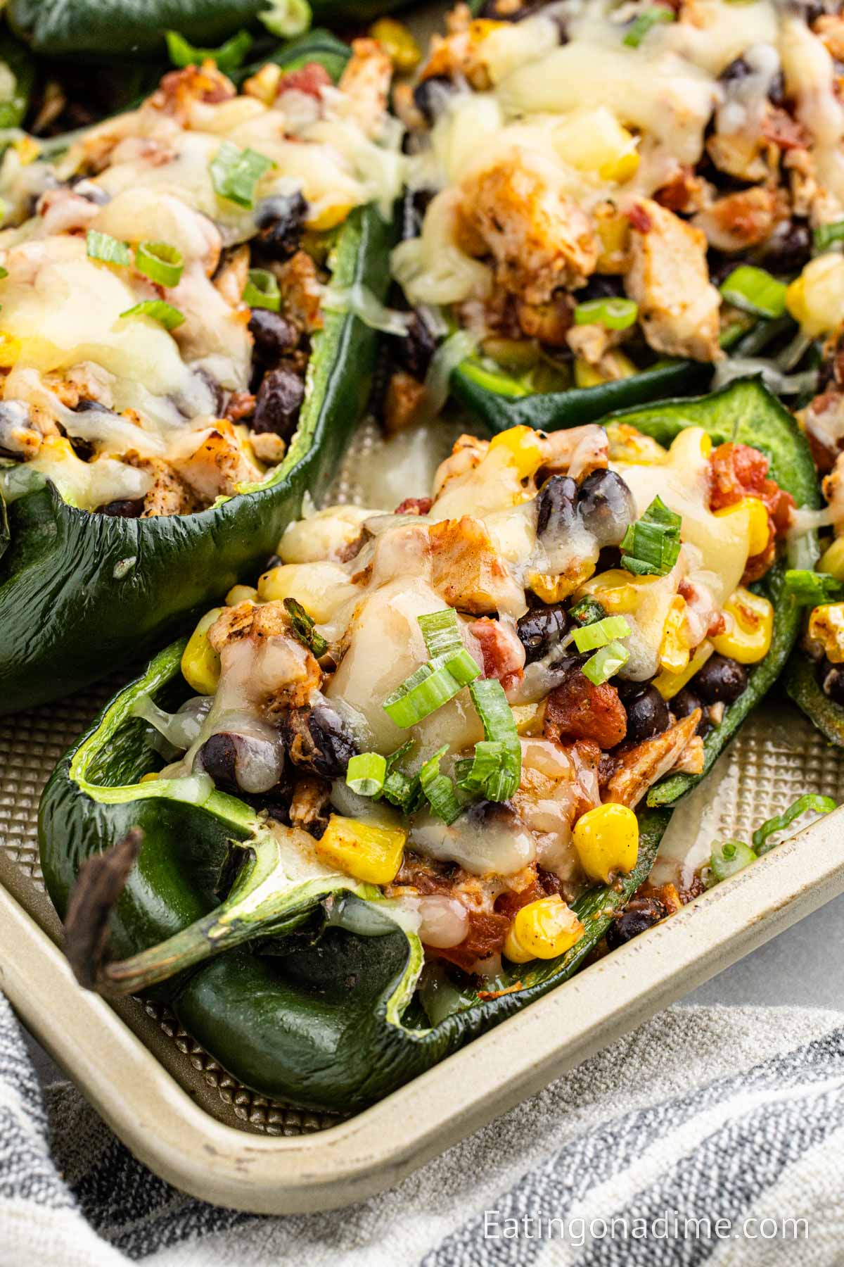 Close up image Chicken Stuffed Poblano Peppers on a baking sheet
