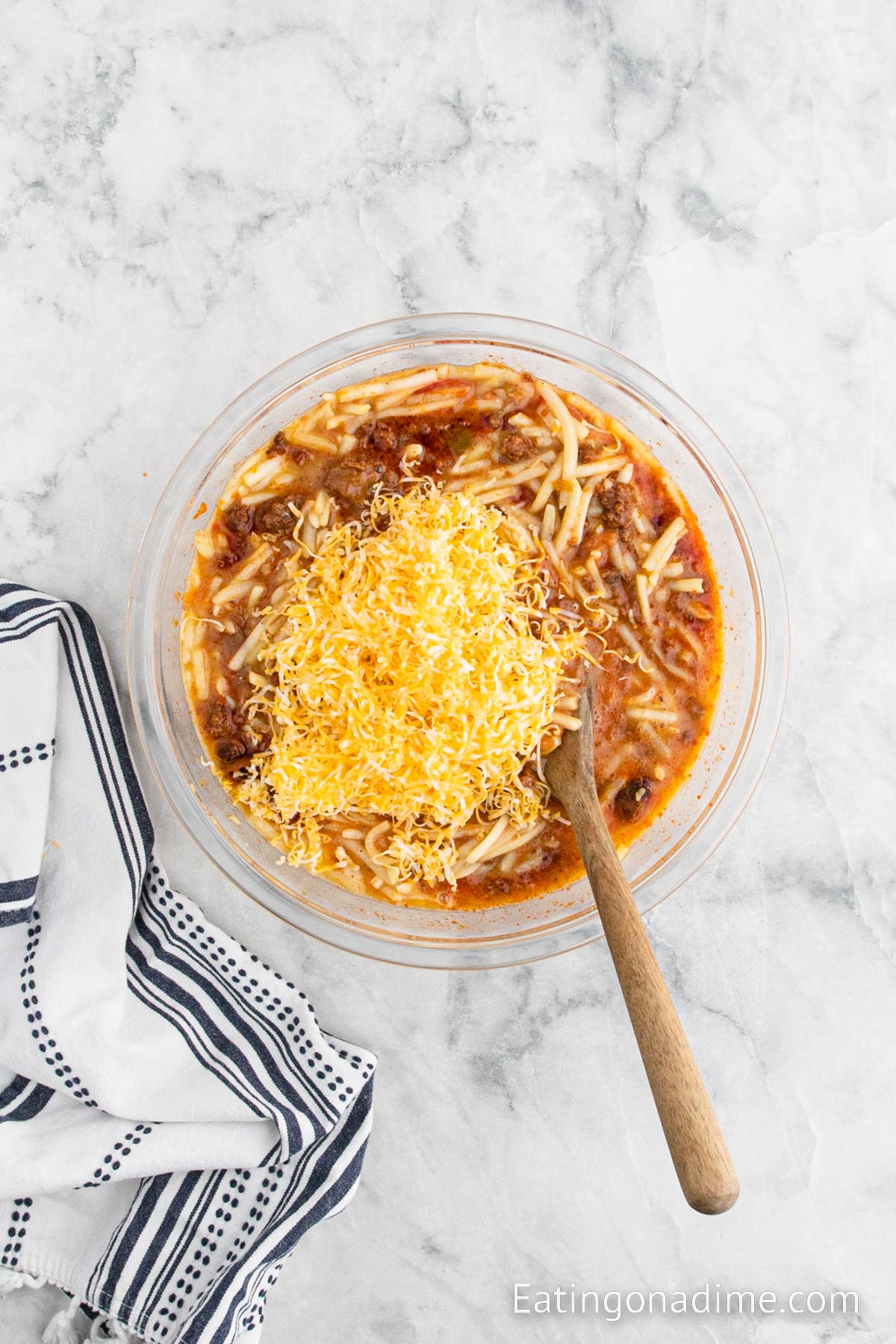 Mix in shredded cheese in a bowl