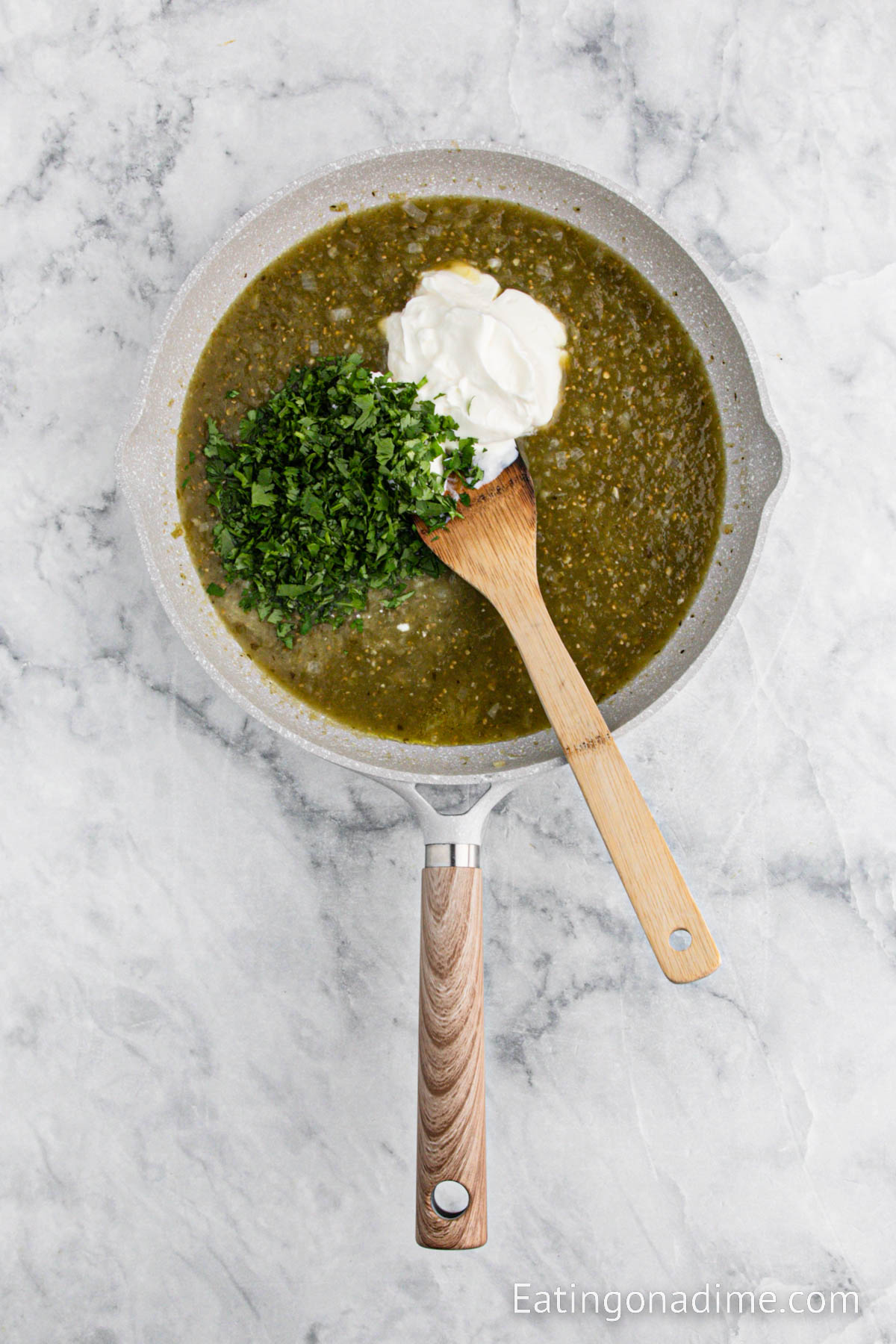 Heating the salsa, sour cream and cilantro in a skillet