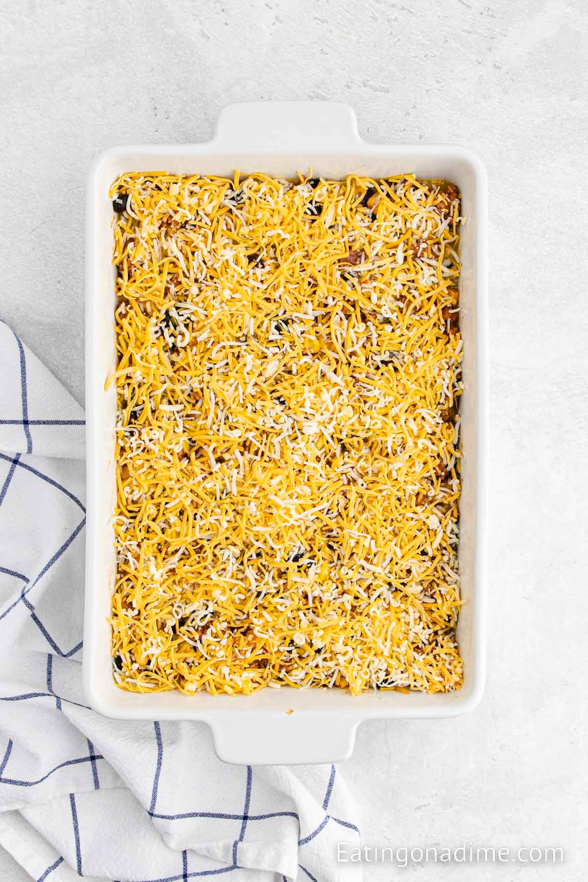 Breakfast casserole topped with shredded cheese