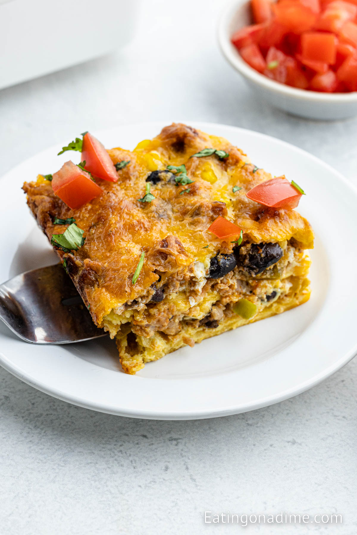 A slice of Mexican breakfast casserole on a plate