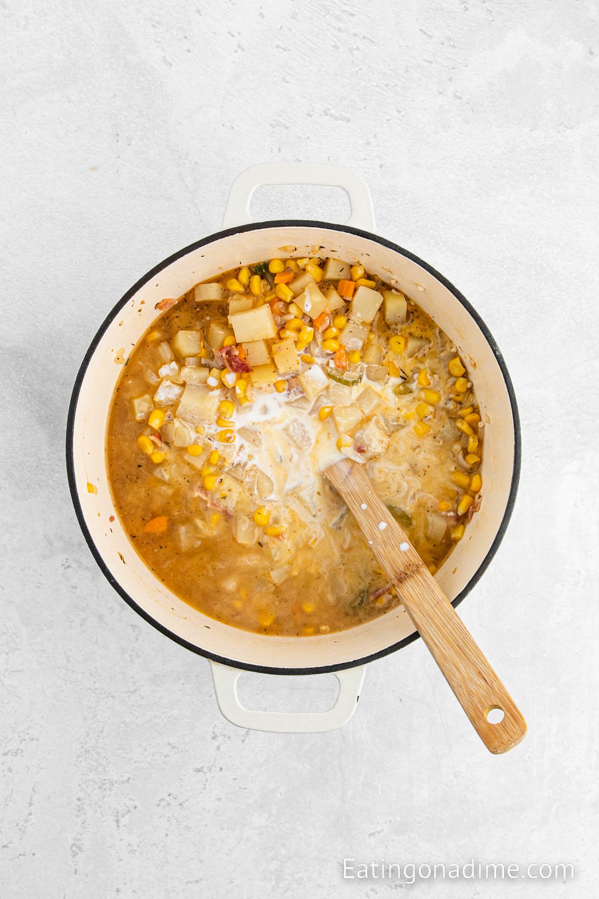 Mixing in the cornstarch slurry into the large pot